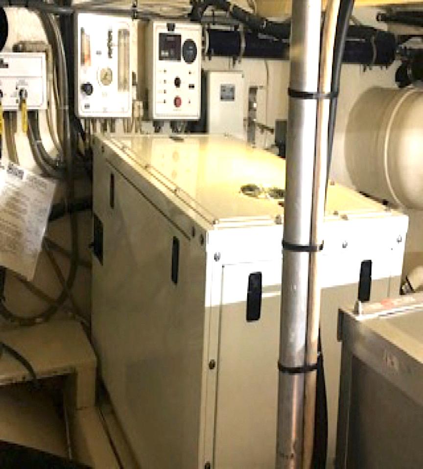 Engine room of a 1998 Defender Cruiser with control panels and machinery.
