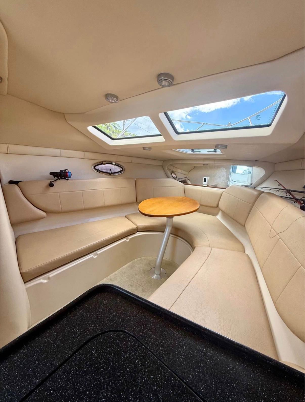 Interior of the 2008 Regal 2565 Window Express with beige seating and a round table.