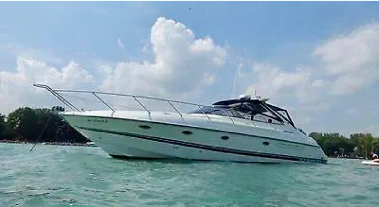 1997 Sunseeker Camargue 47 yacht on calm water under a partly cloudy sky.
