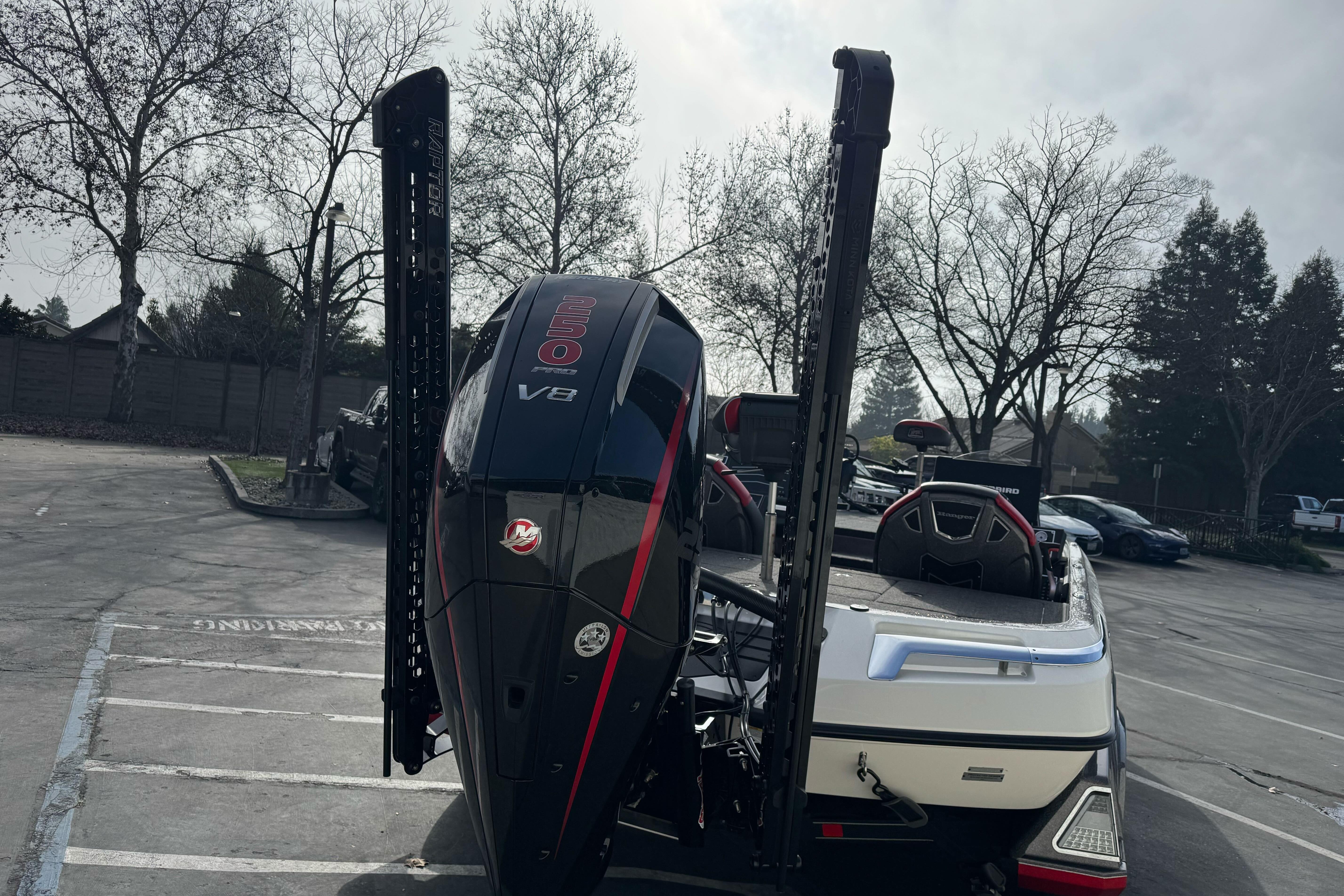 2025 Ranger Z521 boat with V8 engine in a parking lot.