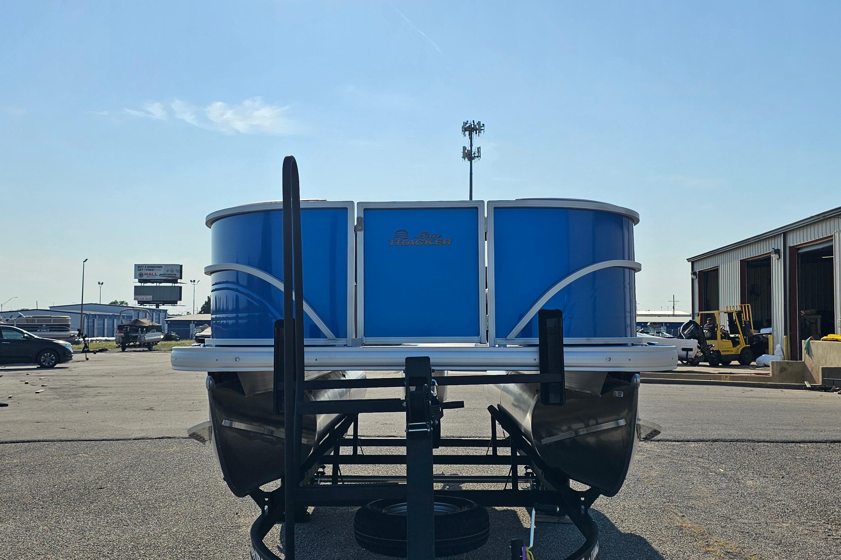 2026 Sun Tracker Party Barge 16 DLX pontoon boat in a parking lot.