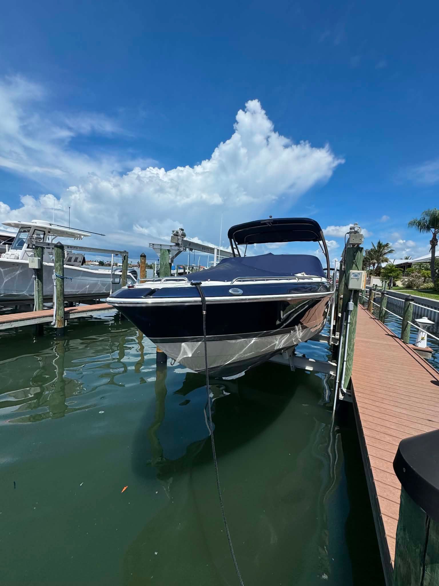2018 Formula 270 Bowrider boat docked under sunny skies.