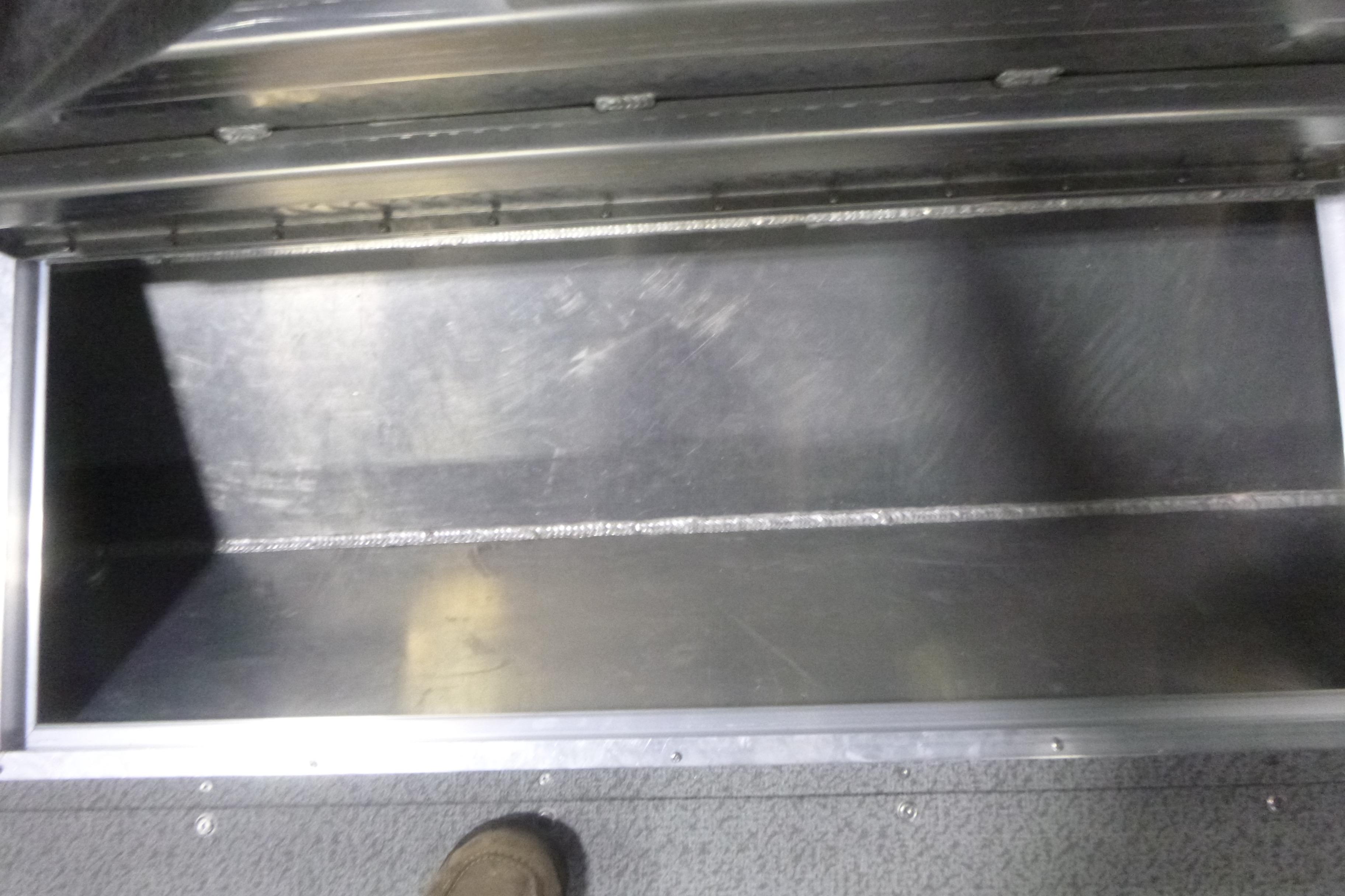 Open storage compartment in 2026 KingFisher 2425 Escape HT boat interior.
