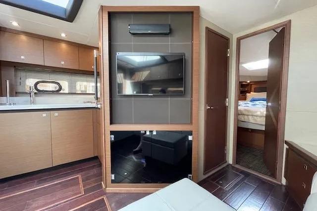 Interior of 2016 Sea Ray Sundancer 510 yacht with modern kitchen and cozy living area.