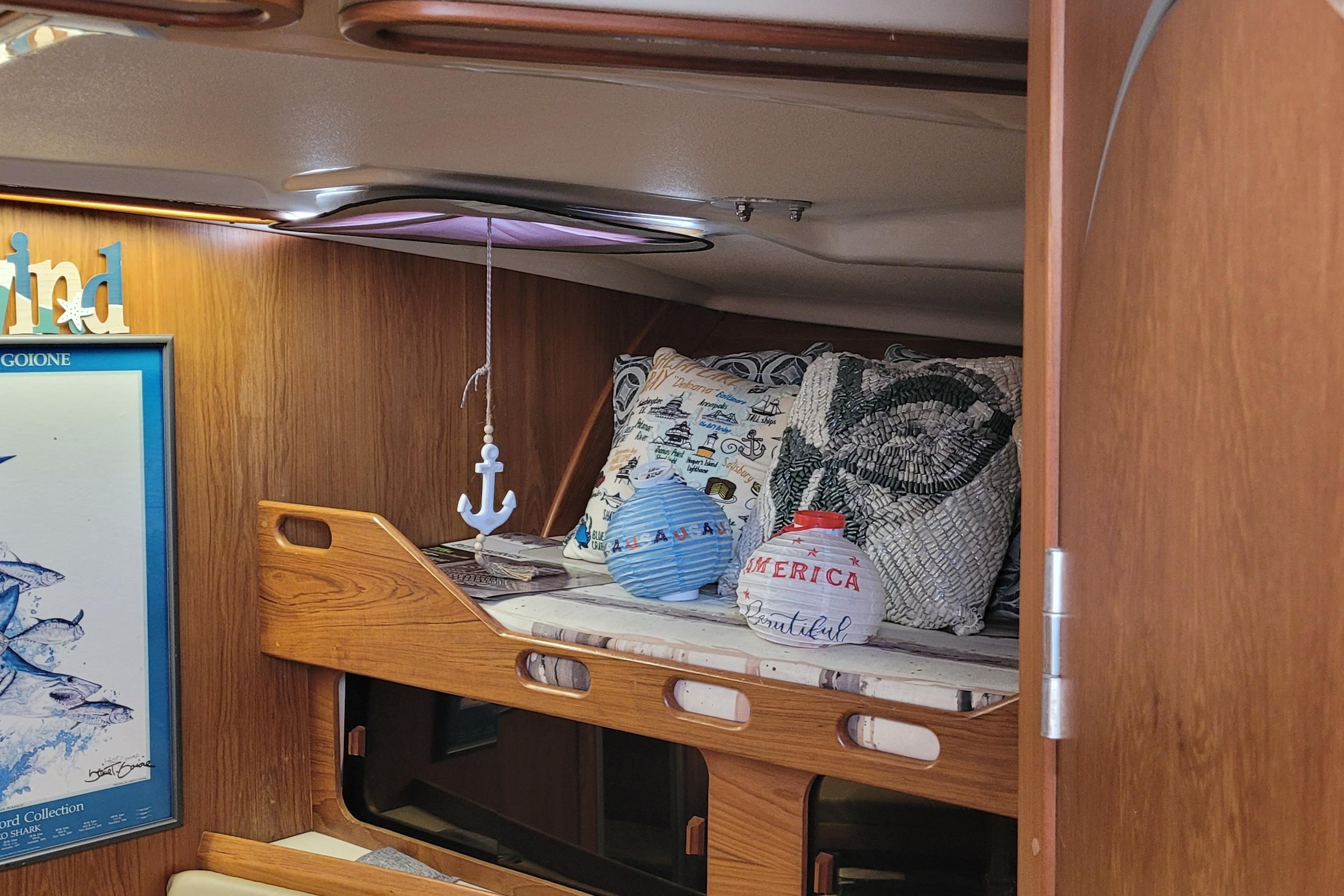 Cozy cabin interior of 1992 Luhrs 380 Open with nautical decor and cushions.