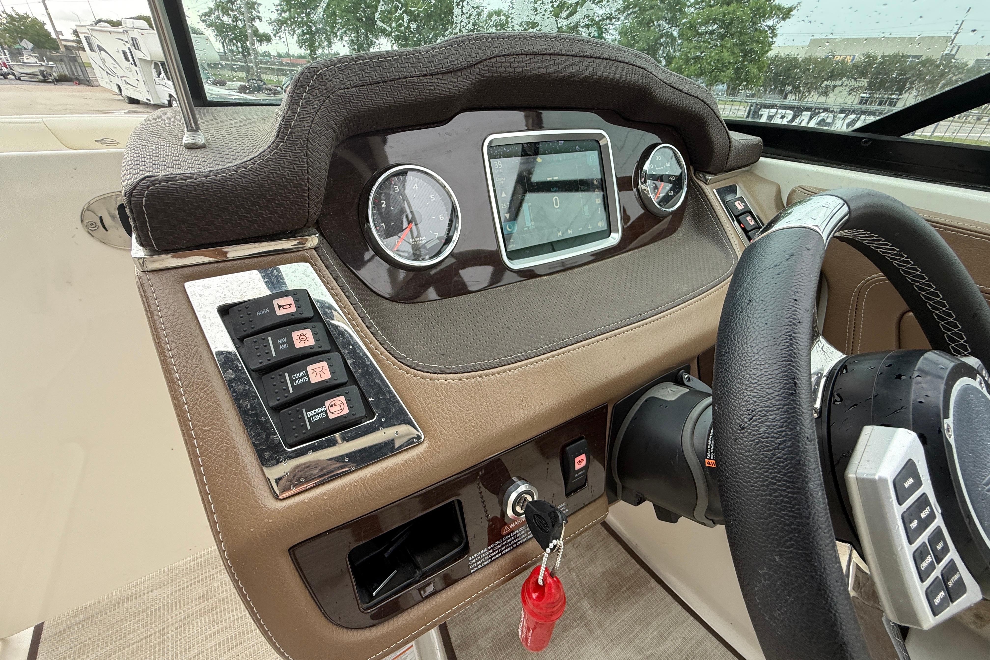 Dashboard of 2018 Chaparral 227 SSX Surf boat with steering wheel and control panel.