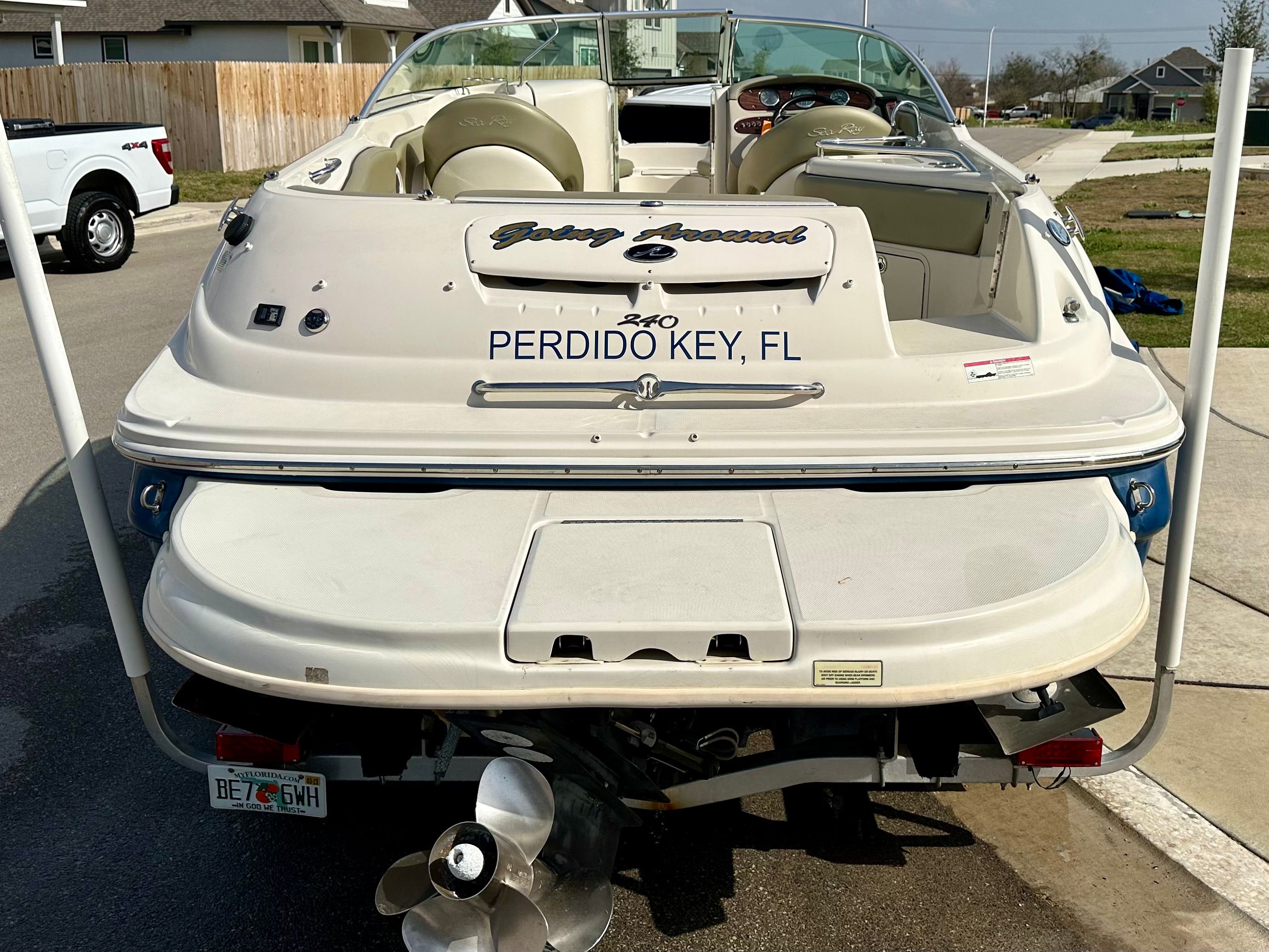 2006 Sea Ray 240 Sundeck boat parked in a residential area.