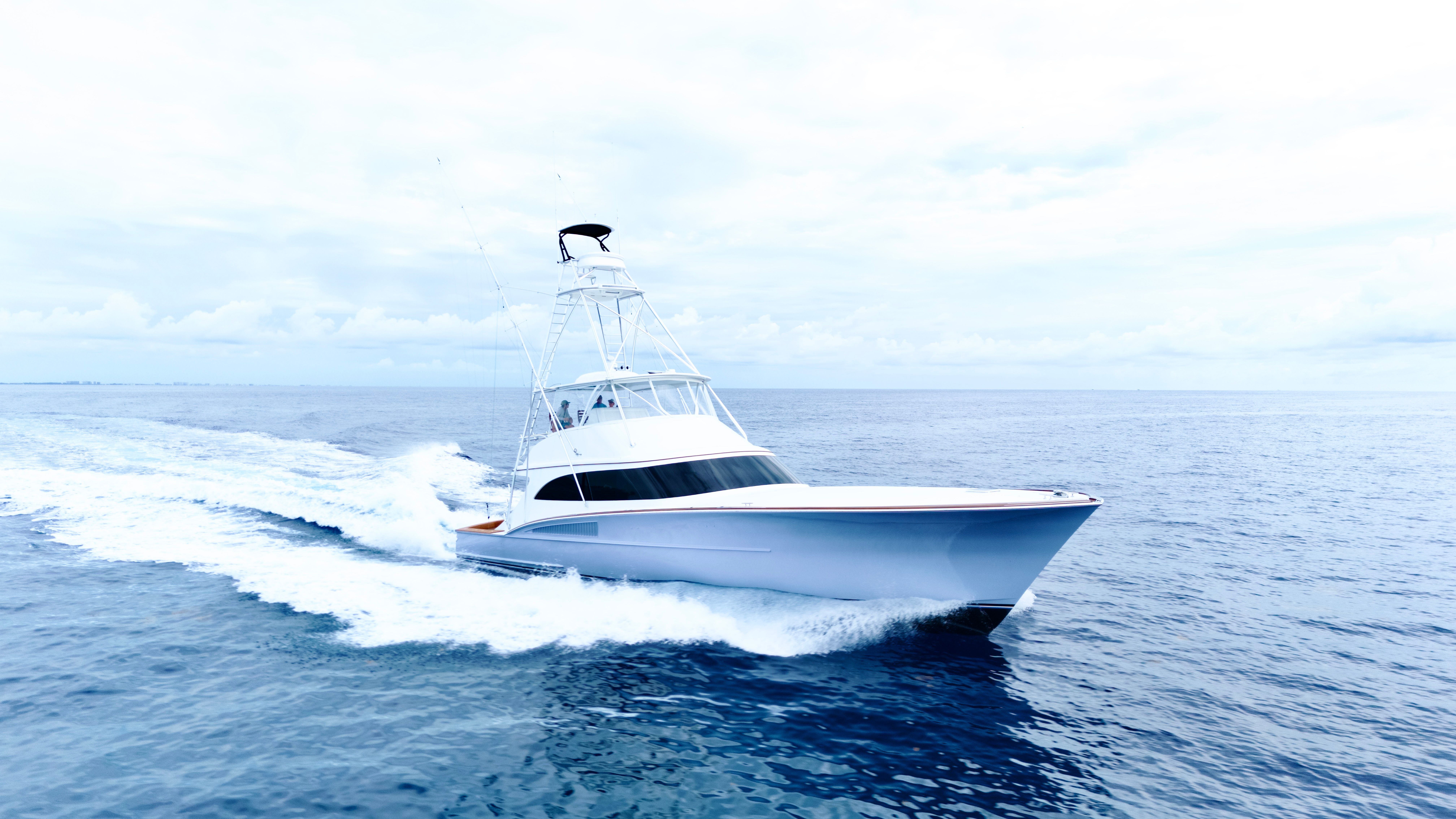 A 2025 Titan Yachts sportfish boat speeding across the open sea.