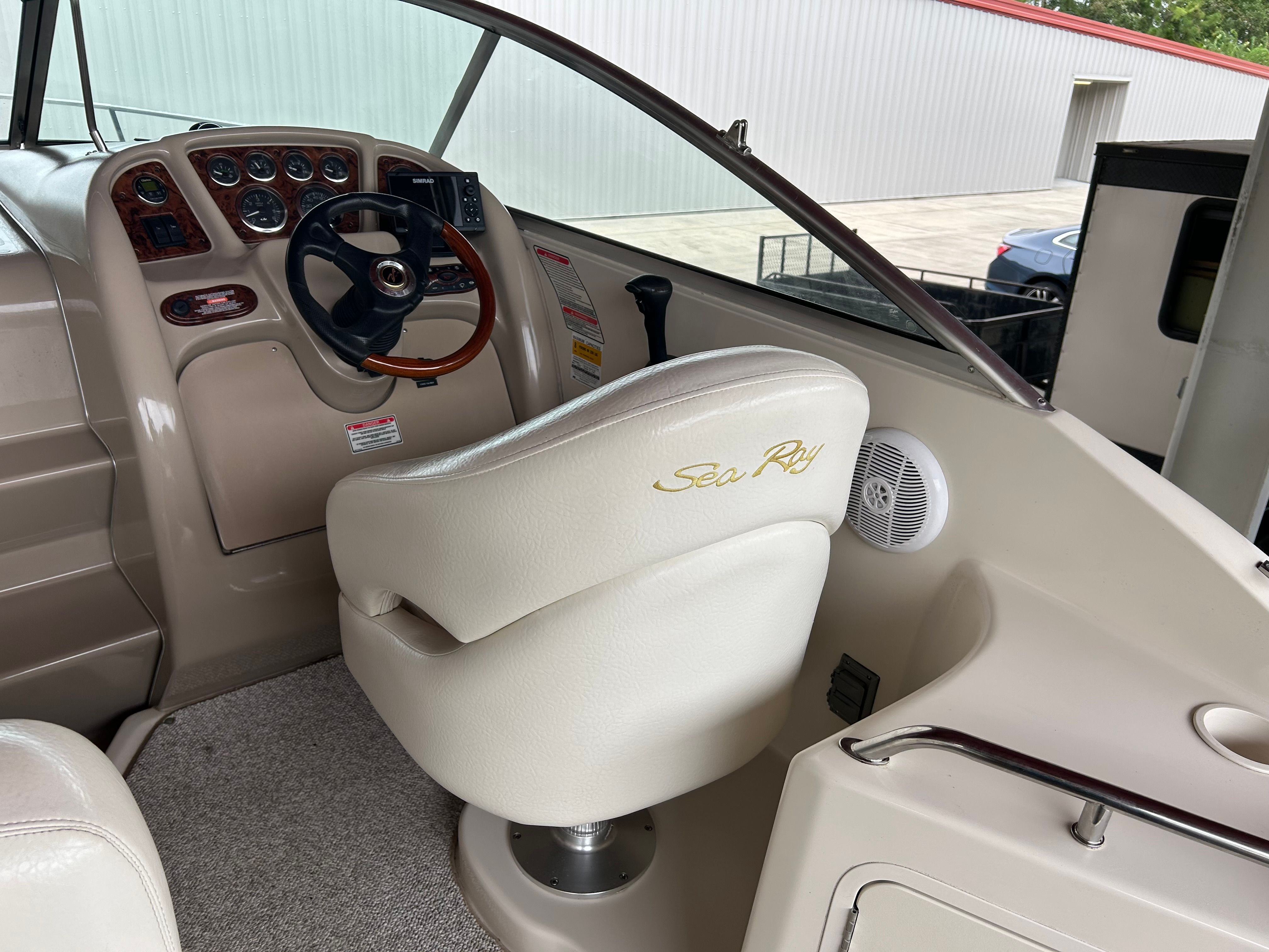 2003 Sea Ray 240 Sundancer helm with steering wheel and control panel.