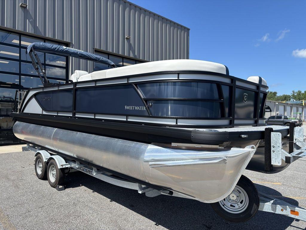2026 Godfrey SWEETWATER 2286 SFL pontoon boat on trailer, parked outdoors.