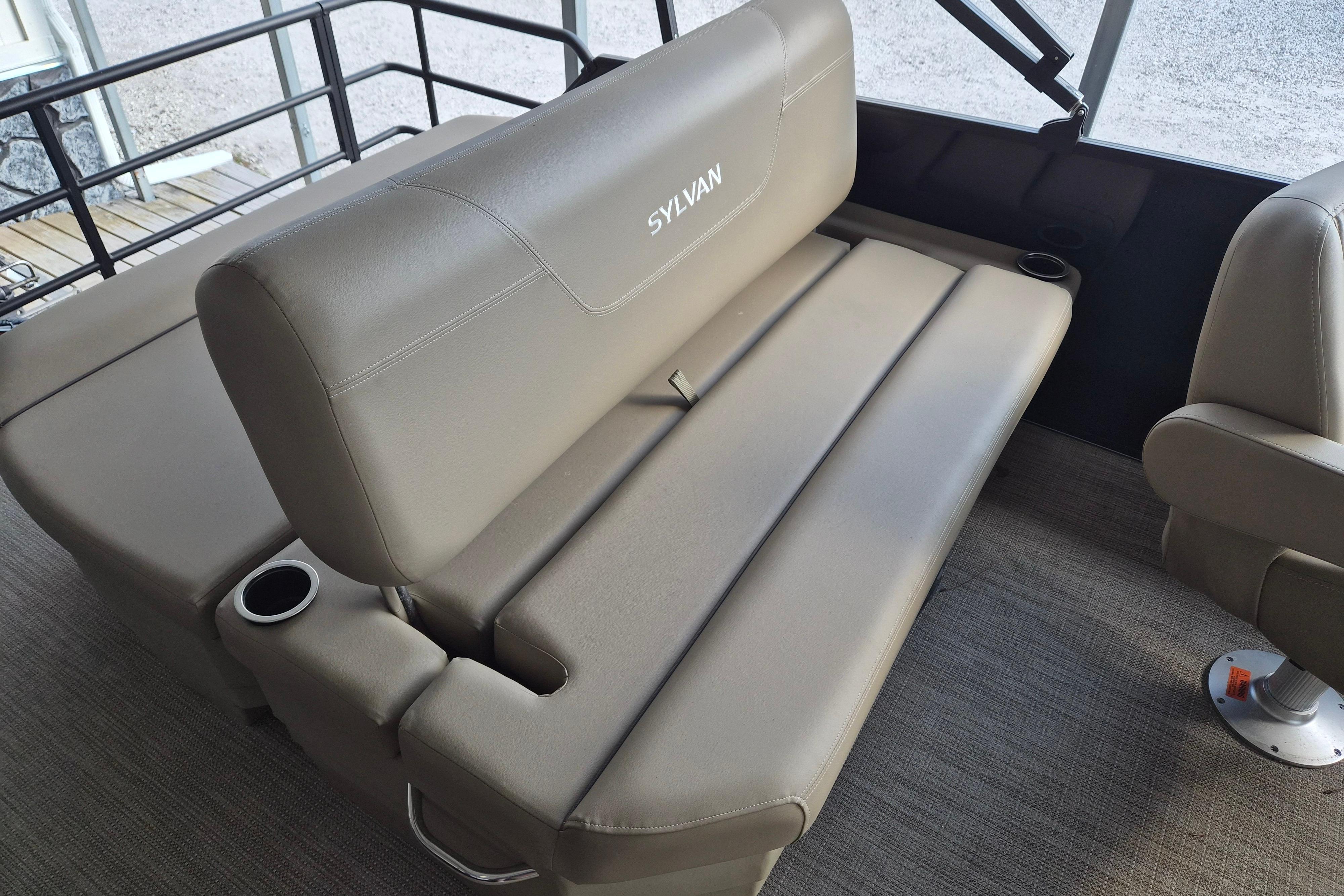 2026 Sylvan Mirage 820 CLZ DH boat interior with beige seating and cup holders.