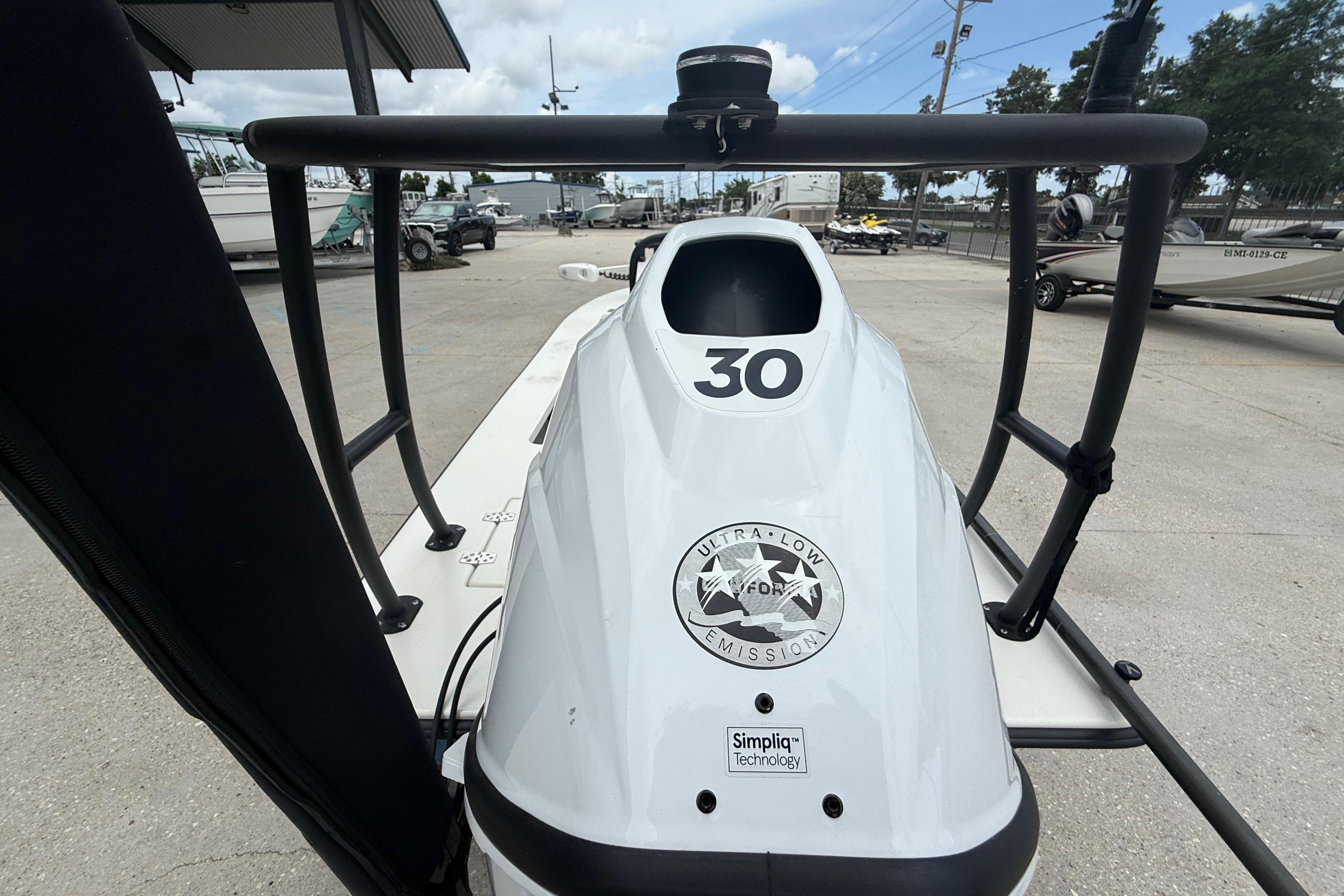 2020 Skimmer Skiff 14 boat with ultra-low emission technology, docked outdoors.