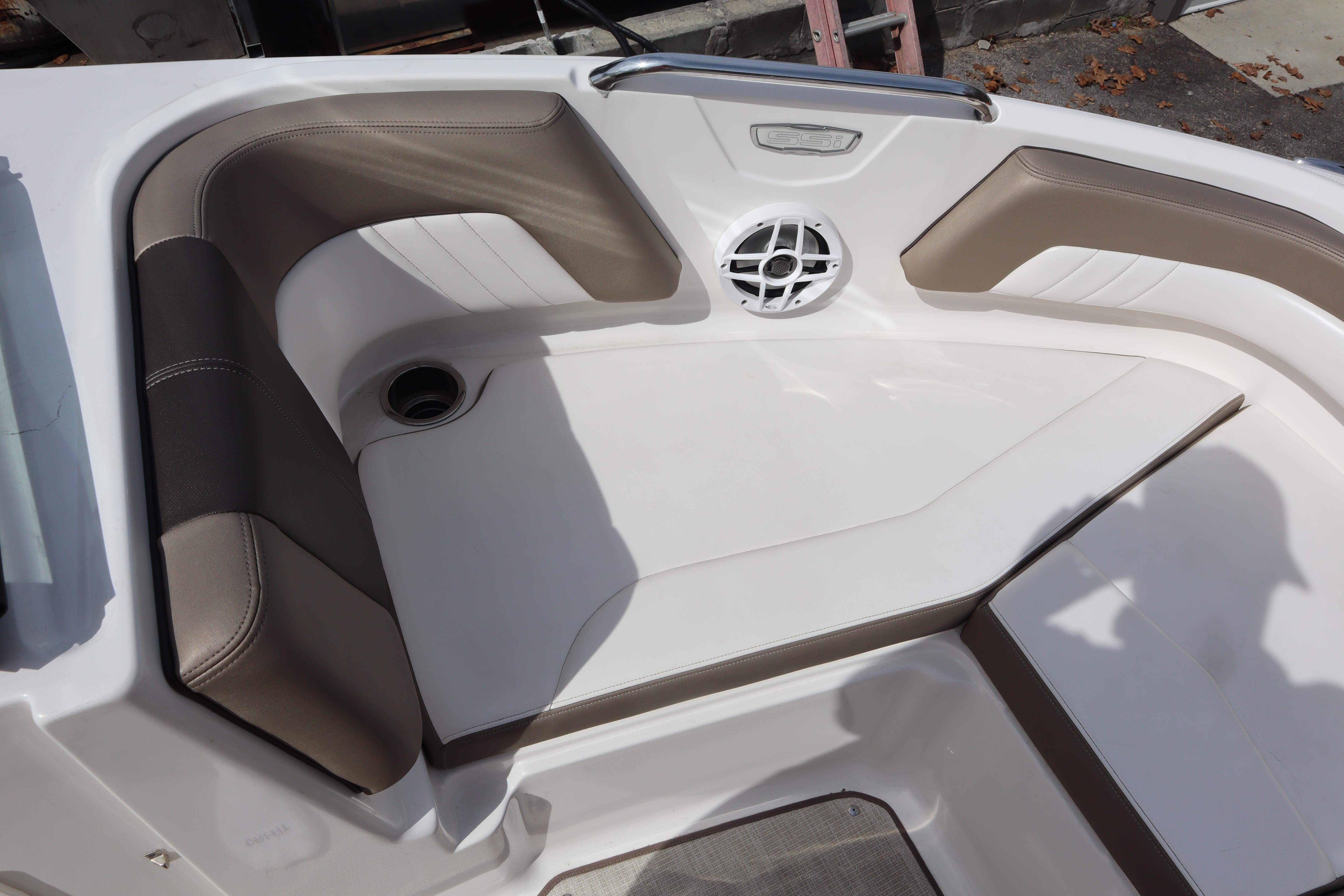 2021 Chaparral 21 SSi boat interior with cushioned seating and speaker.