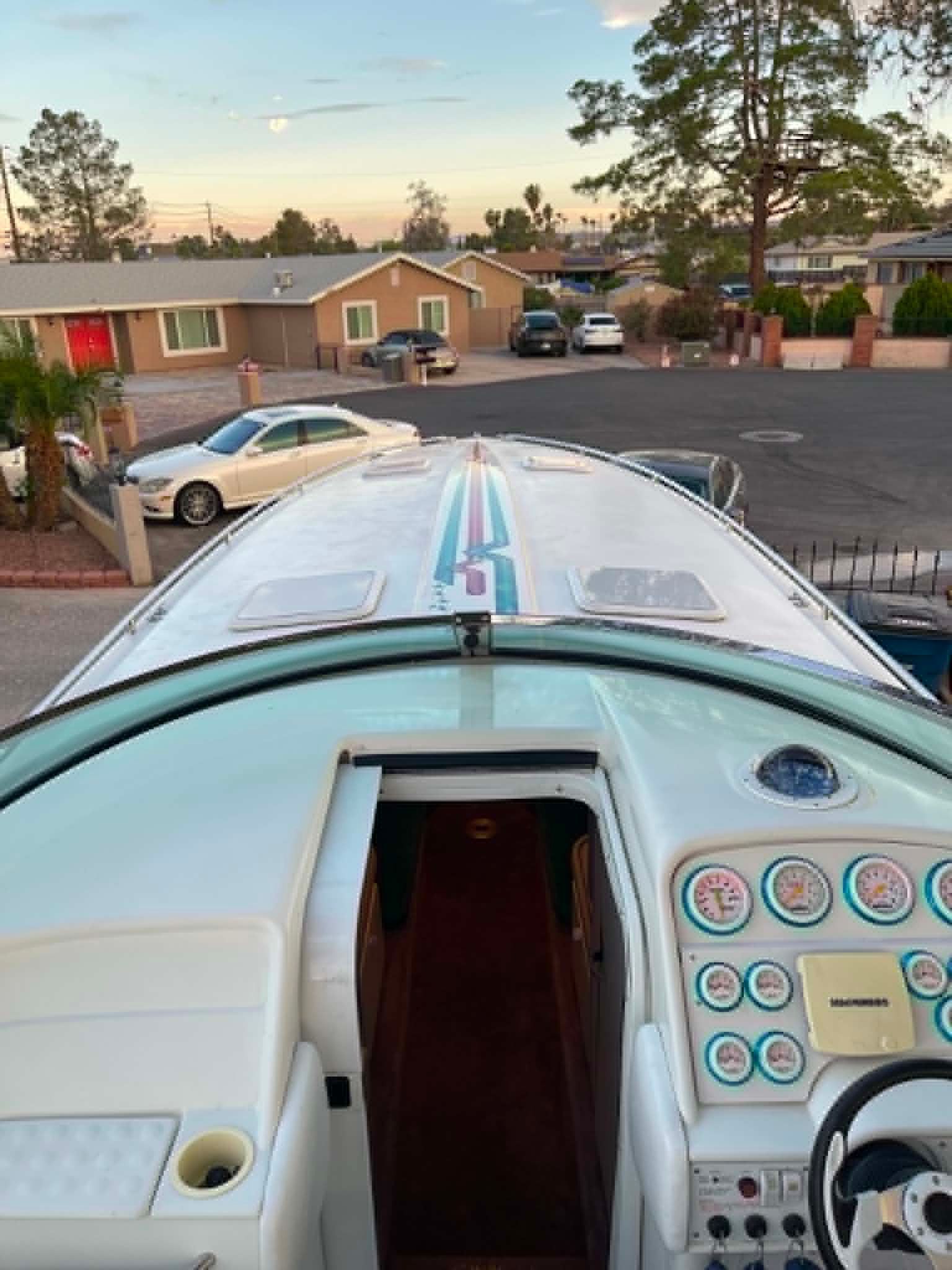 The image shows the cockpit of a 2000 Formula 419 Fast Tech boat. It is parked in a driveway.