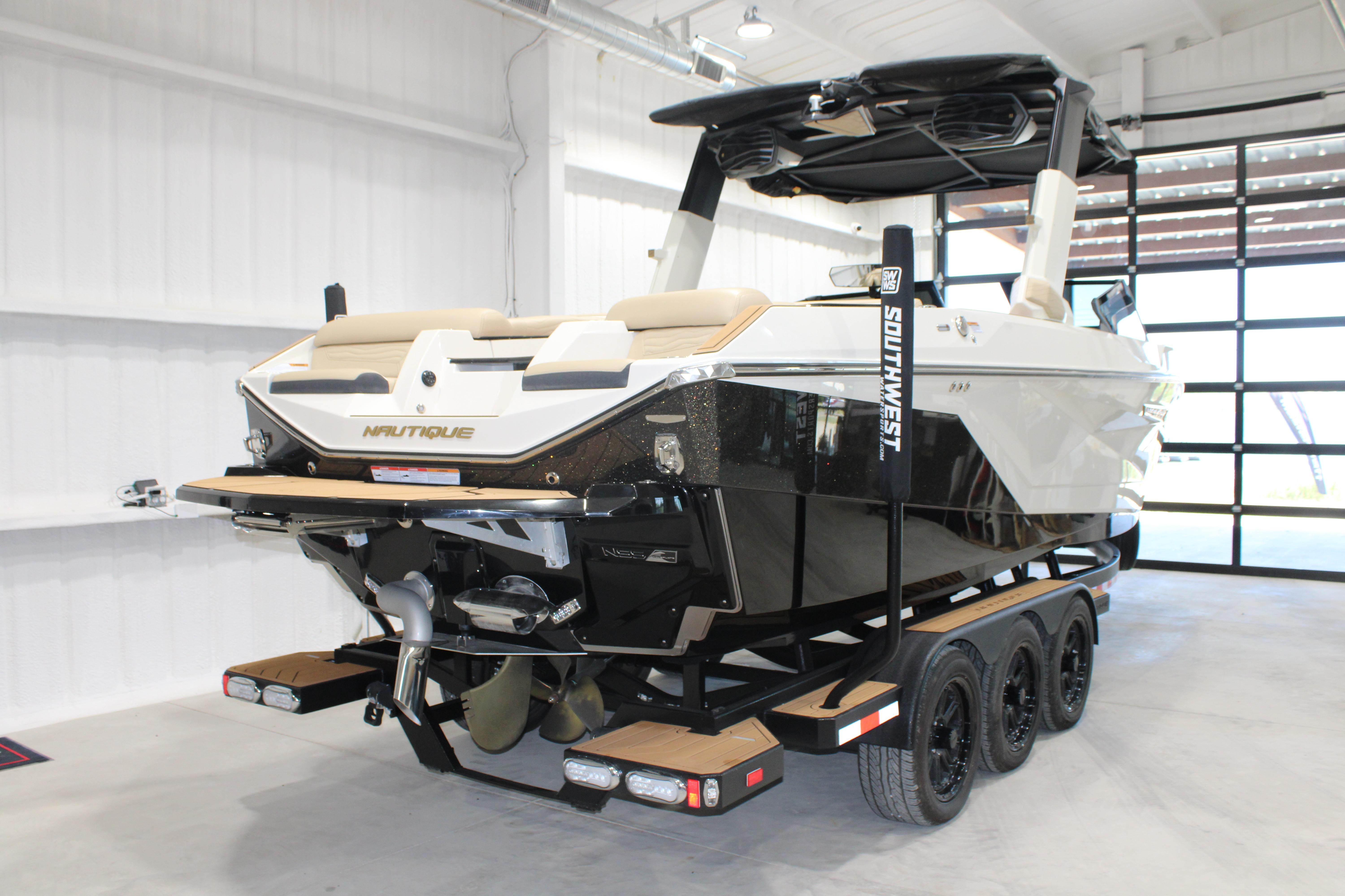 2025 Nautique Super Air Nautique G25 boat on trailer in showroom.
