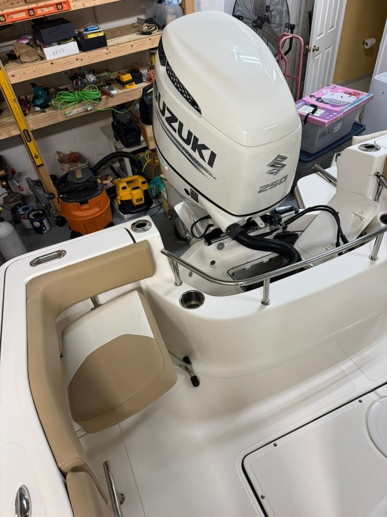 Pioneer 22 SF boat with Suzuki 250 engine in a workshop.