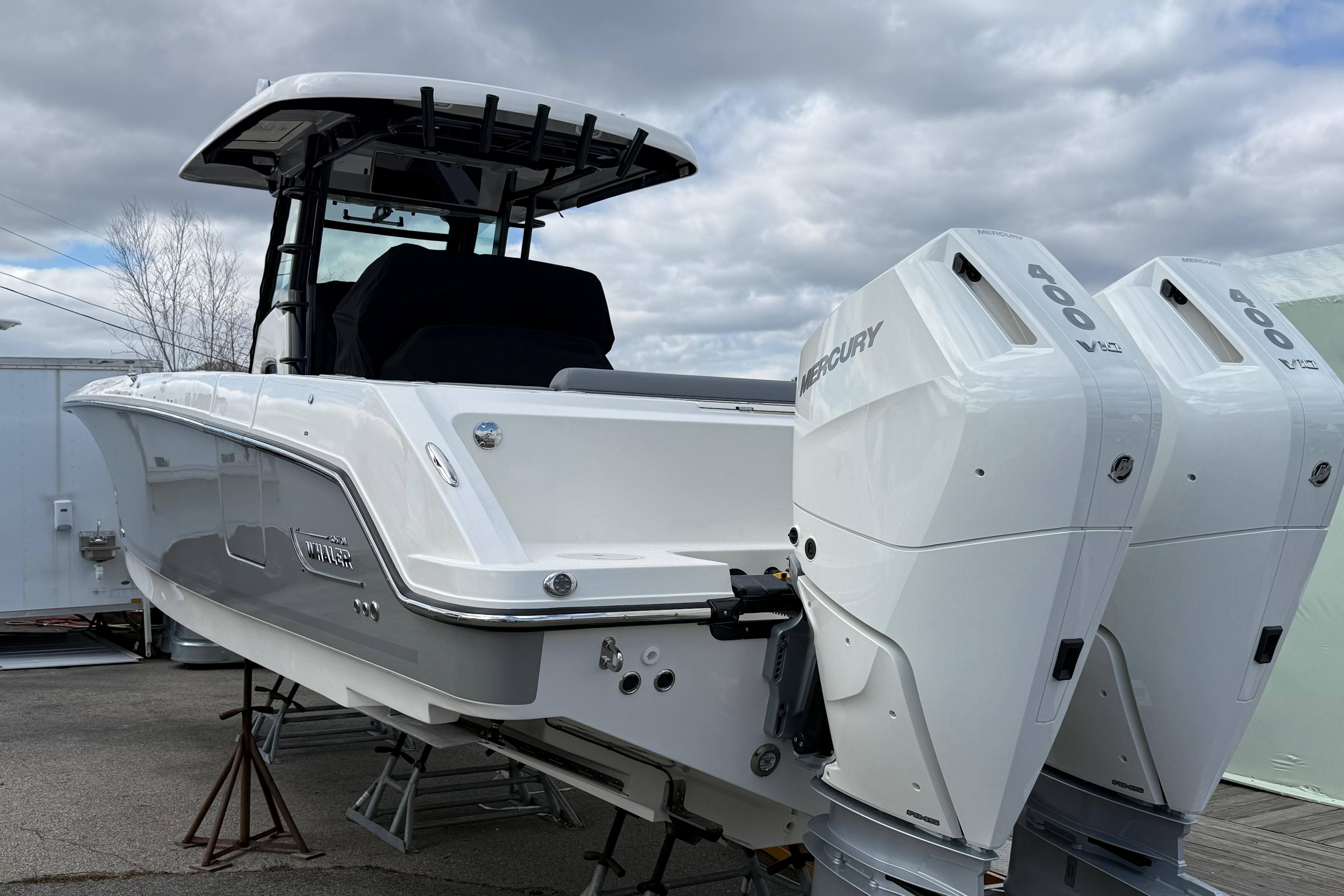 2026 Boston Whaler 330 Outrage boat with dual Mercury 400 engines, displayed outdoors.