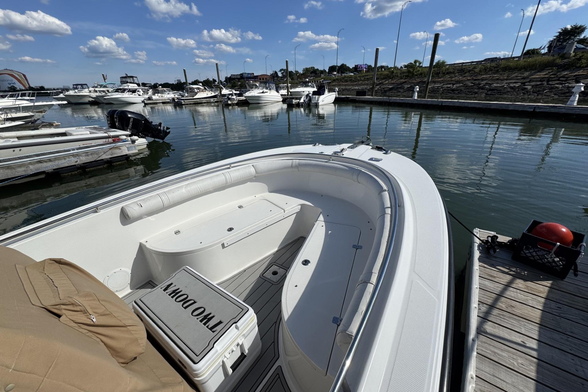 Edgewater 245CC 2007 boat docked in a marina with clear skies.