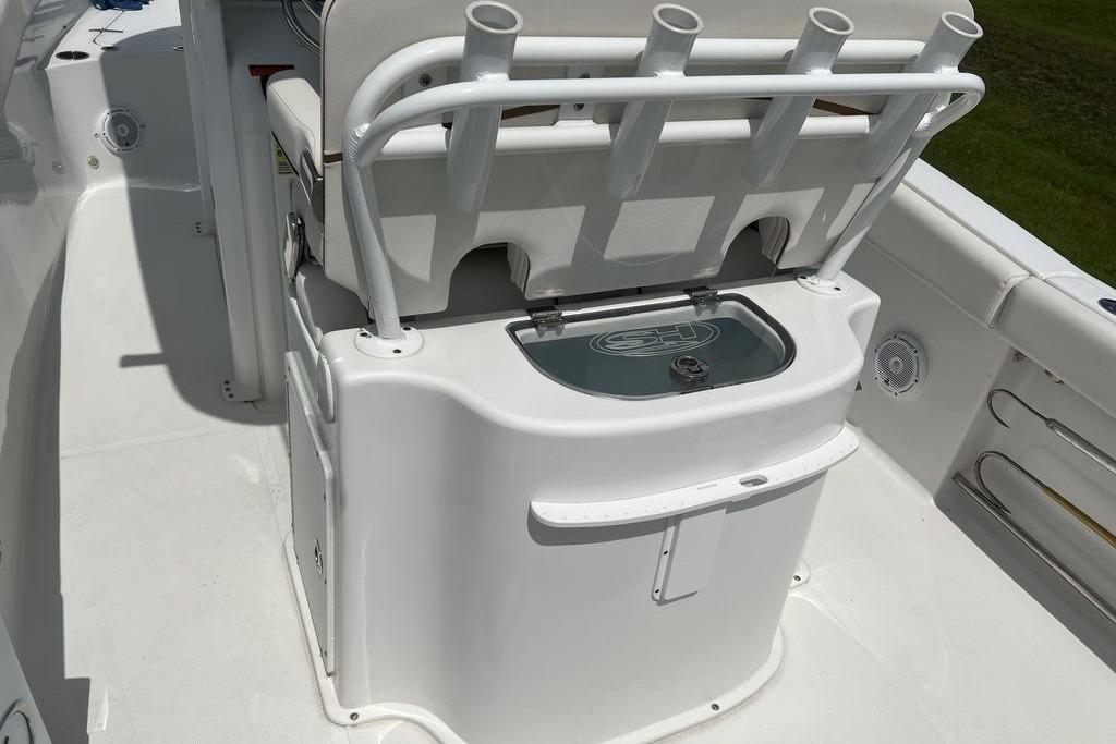 2021 Sea Hunt Gamefish 25 boat interior with rod holders and storage compartment.