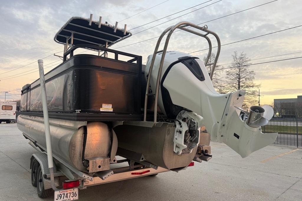 2022 Apex Marine 8524 Pro Fish N Cruise pontoon boat on trailer at sunset.