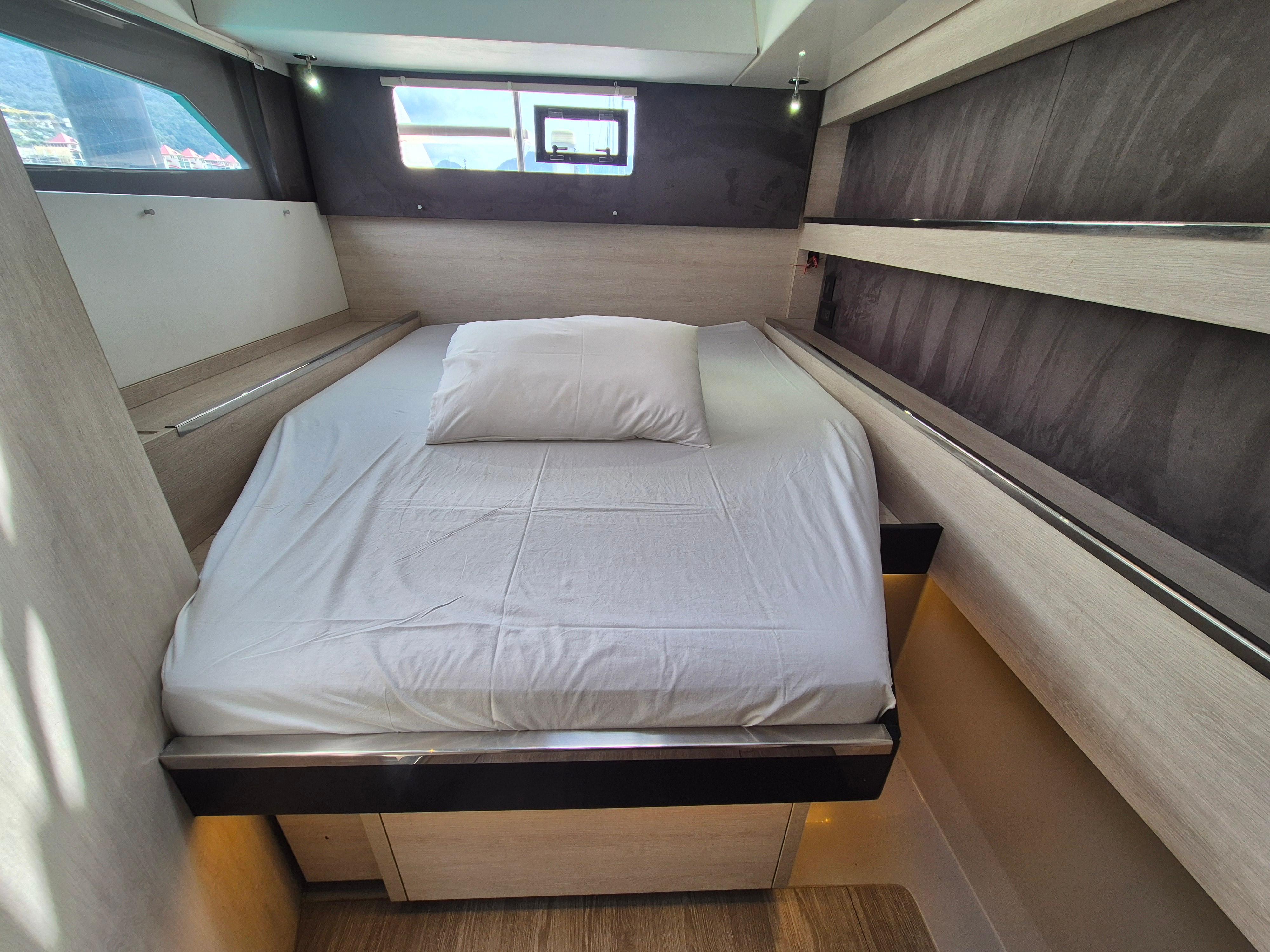 Cozy bedroom in 2020 Leopard 50 yacht with modern design and natural light.