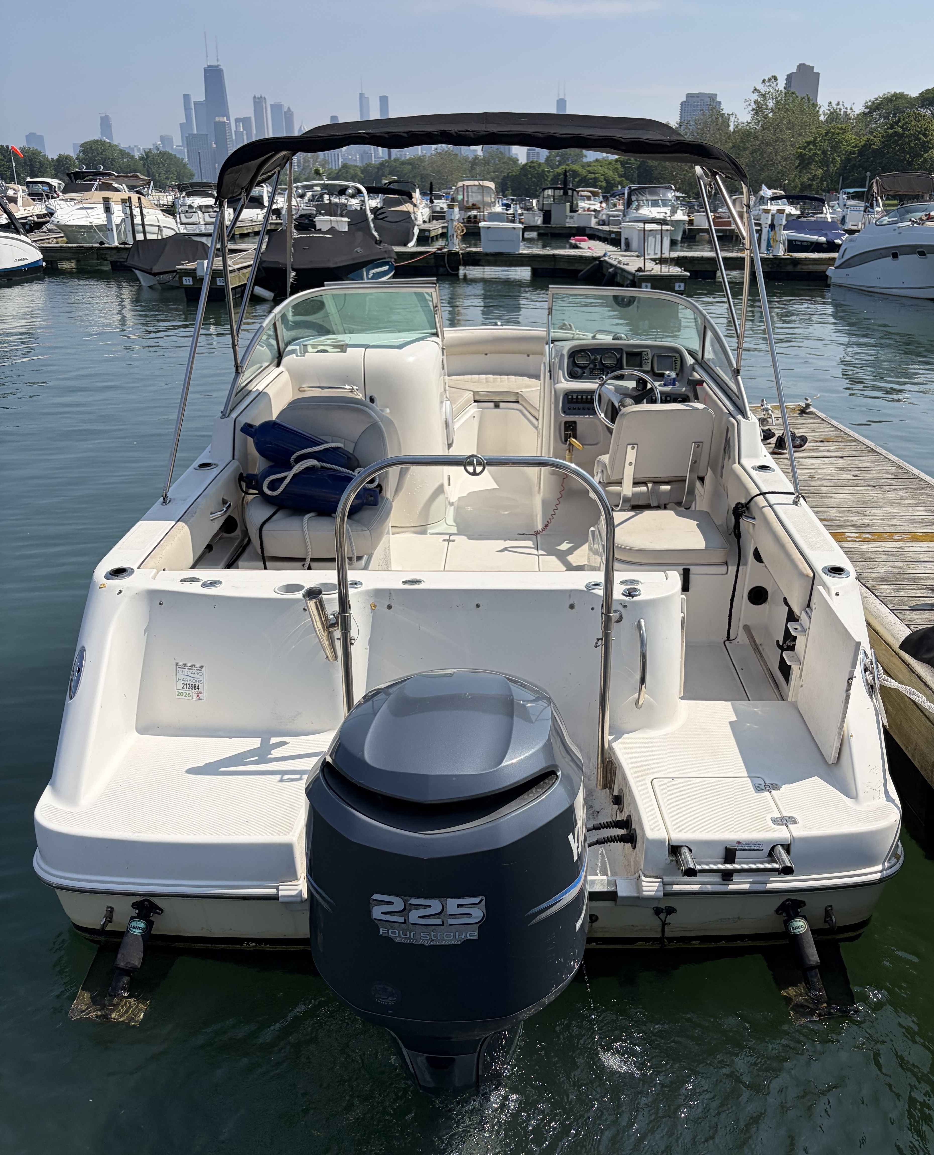 A 2005 Robalo R227 Dual Console boat is docked on the water.
