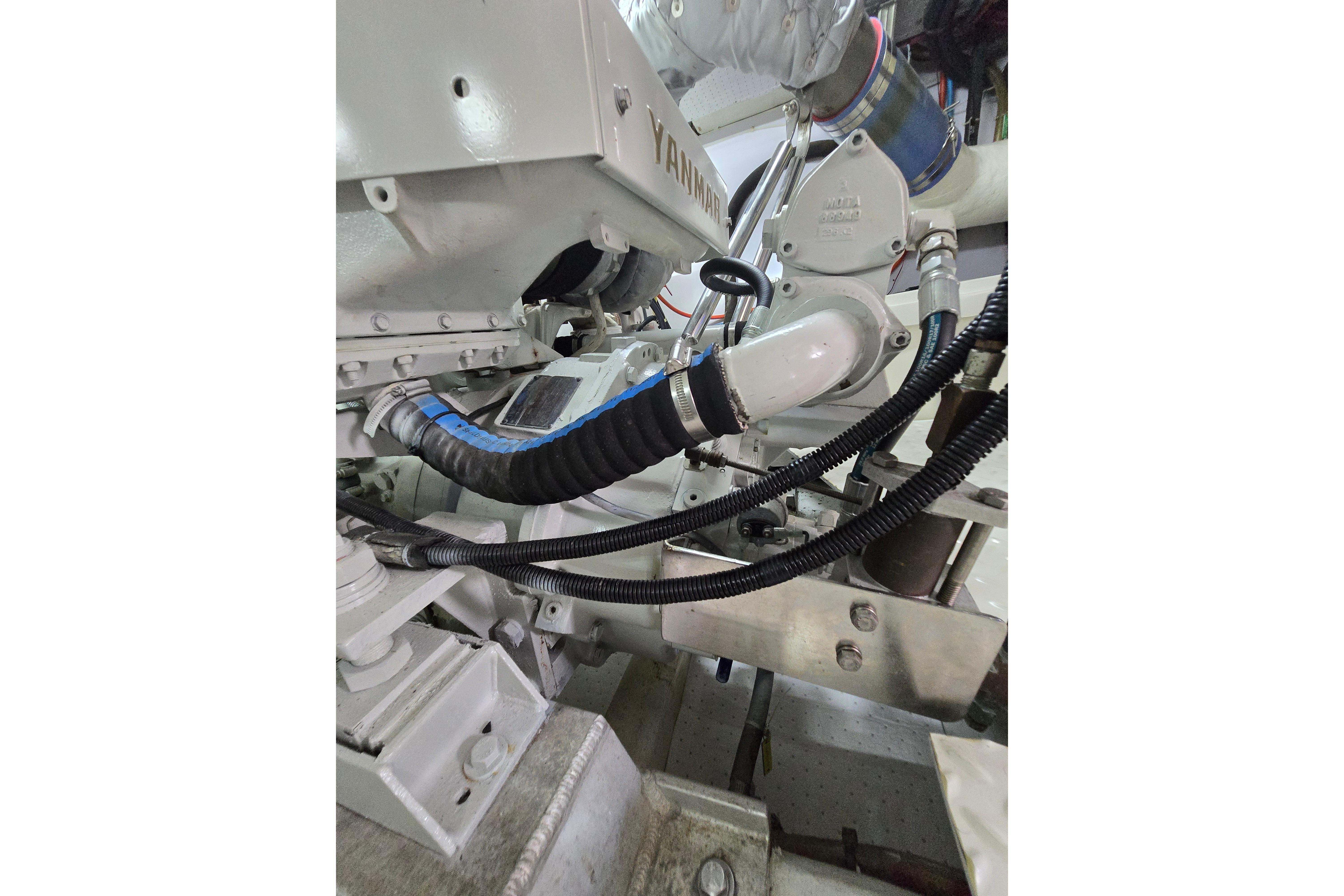 Engine components of a 2004 Grand Harbour 58 yacht, featuring Yanmar parts and hoses.