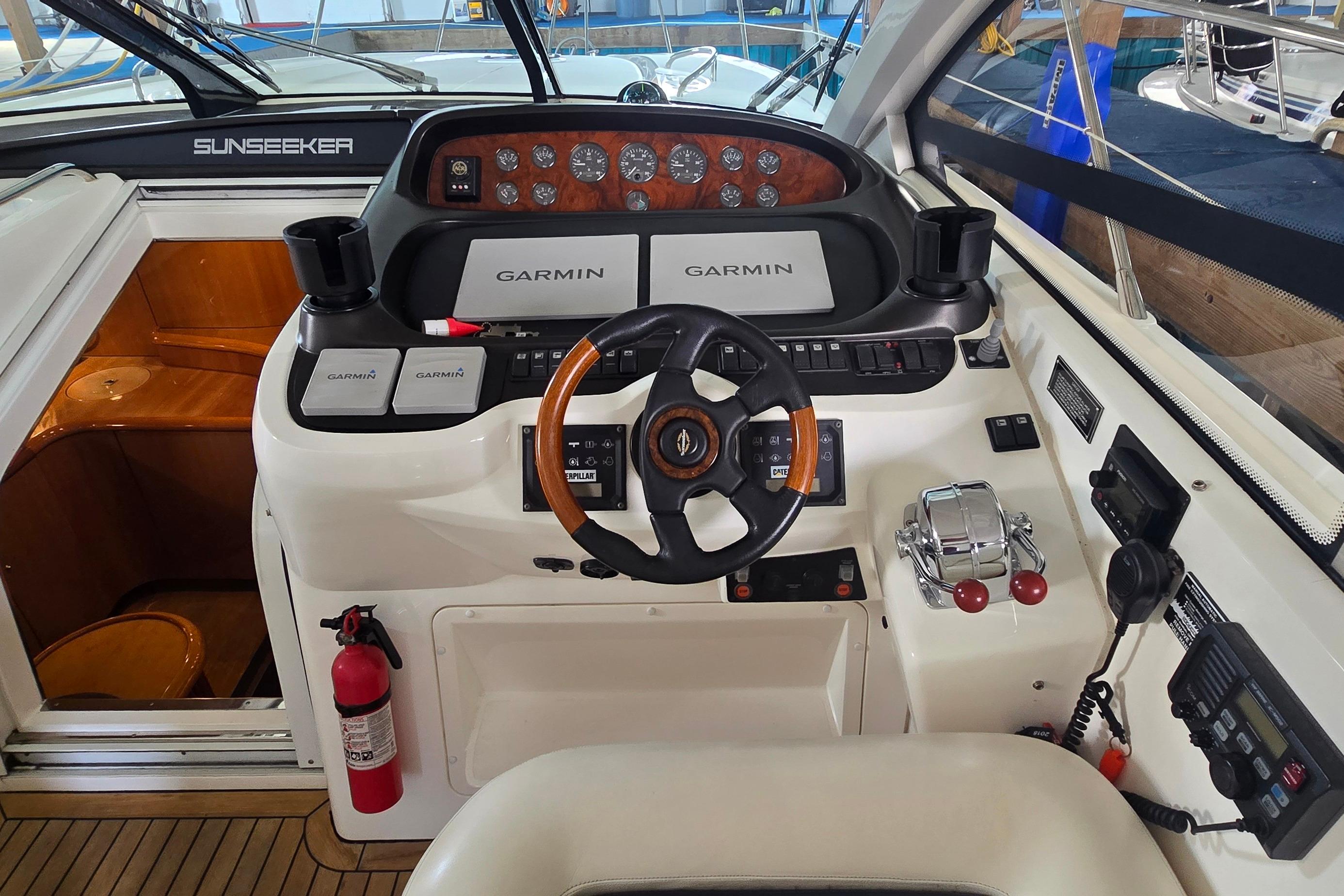 Cockpit of 2004 Sunseeker Camargue 50 with Garmin navigation system and steering wheel.