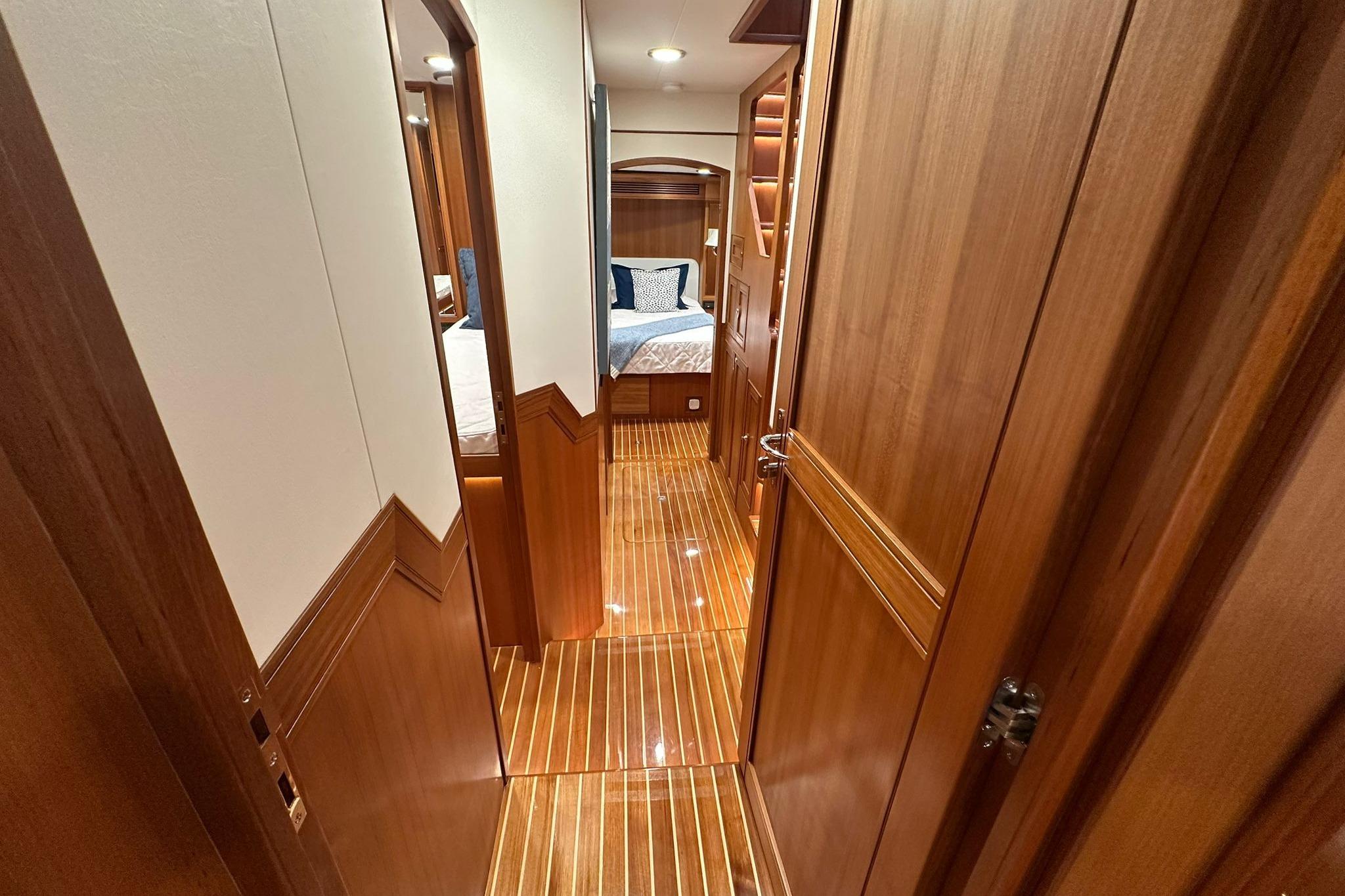 Luxurious interior of 2023 Marlow Explorer 66E-CB yacht with polished wood finish.