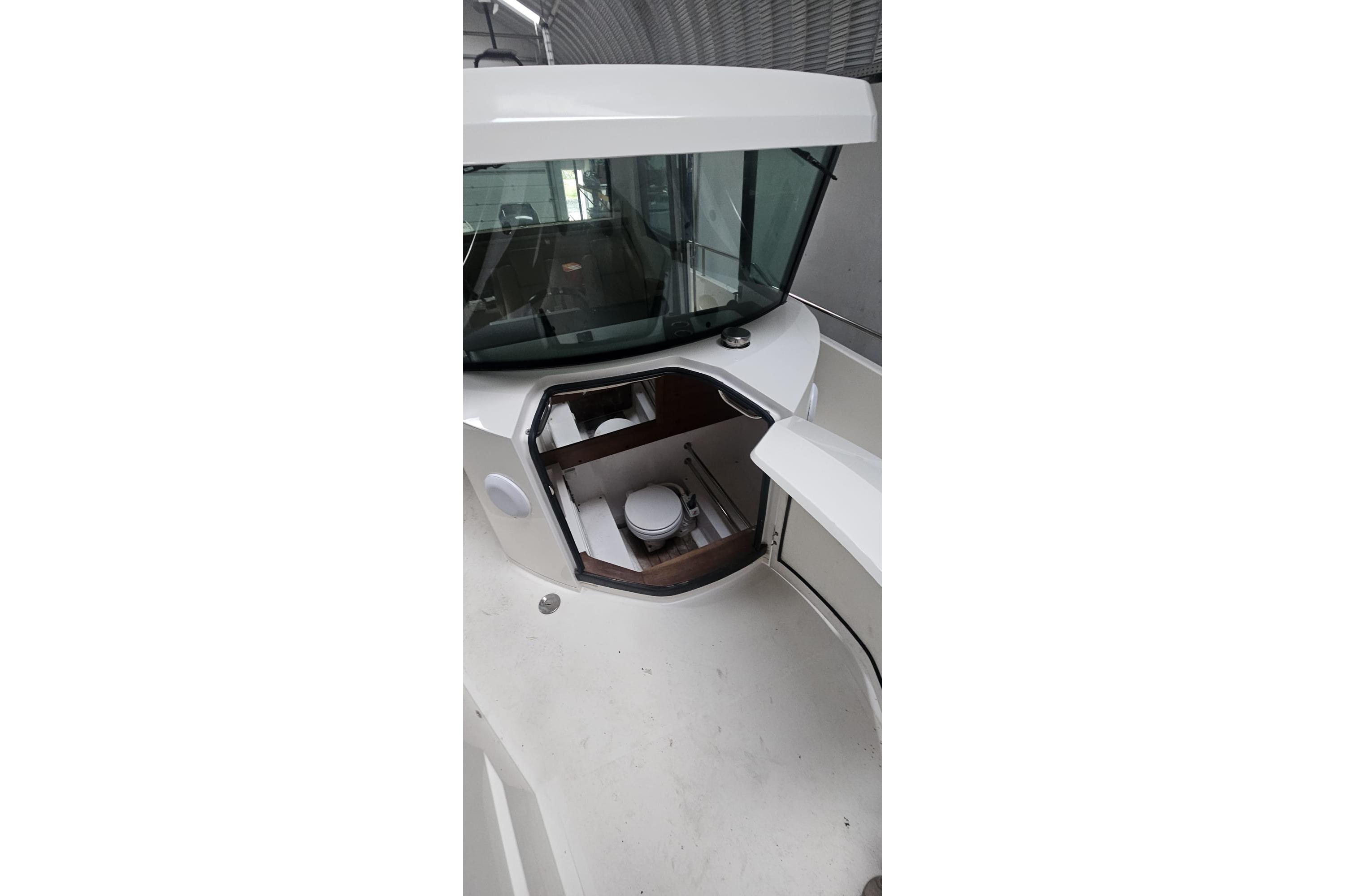 2015 Axopar 28 Cabin boat interior with open hatch and visible toilet.