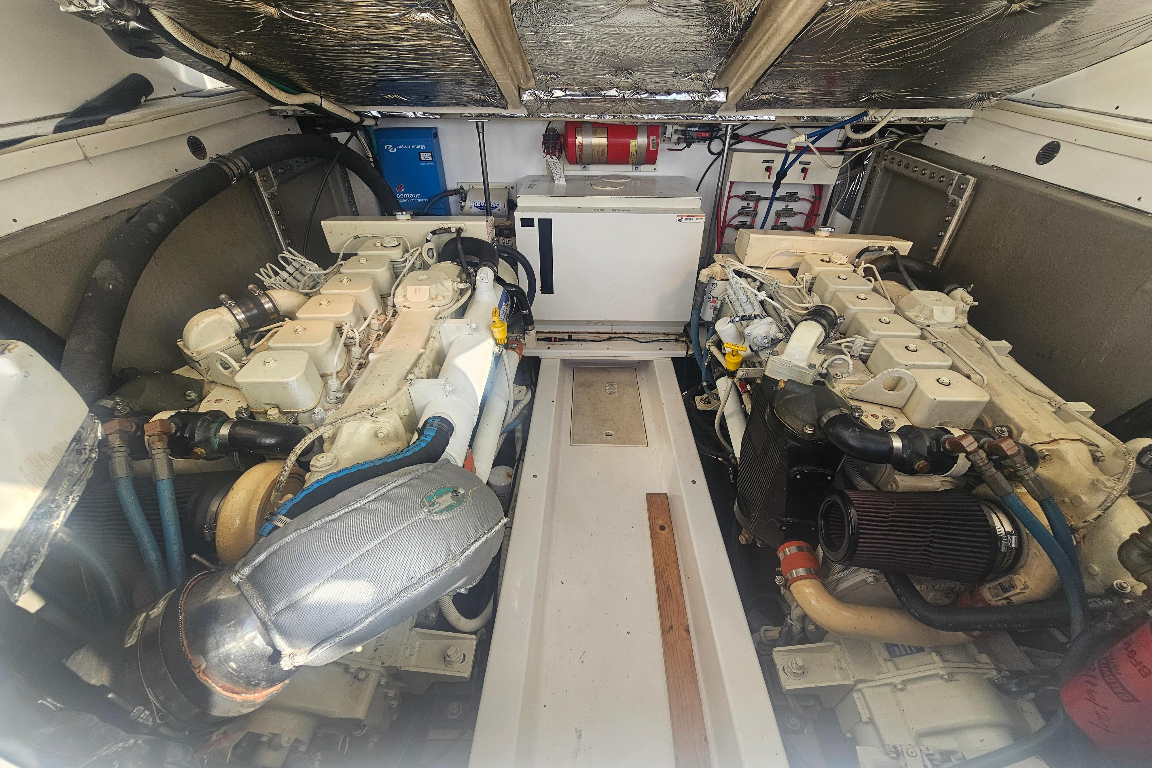 Engine room of 2003 Topaz 32 Express boat, featuring dual engines and equipment.