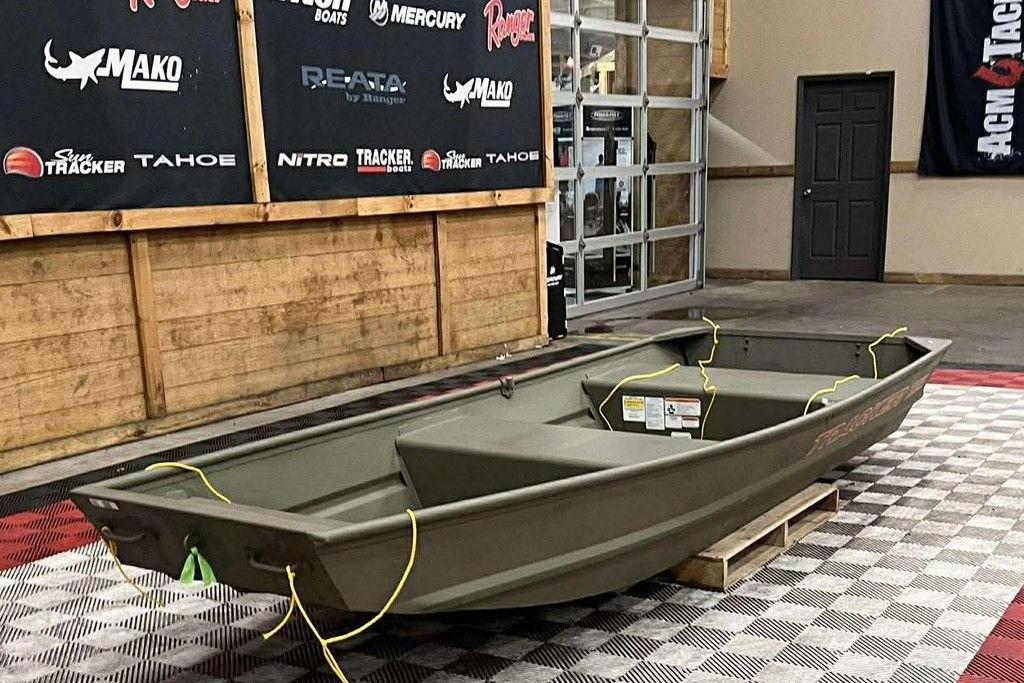 2026 Tracker Grizzly 12 Jon boat displayed indoors on checkered flooring.