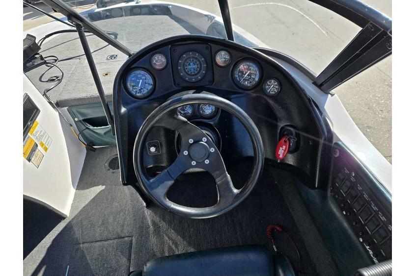 1997 Javelin 389 FS boat dashboard with steering wheel and instrument panel.