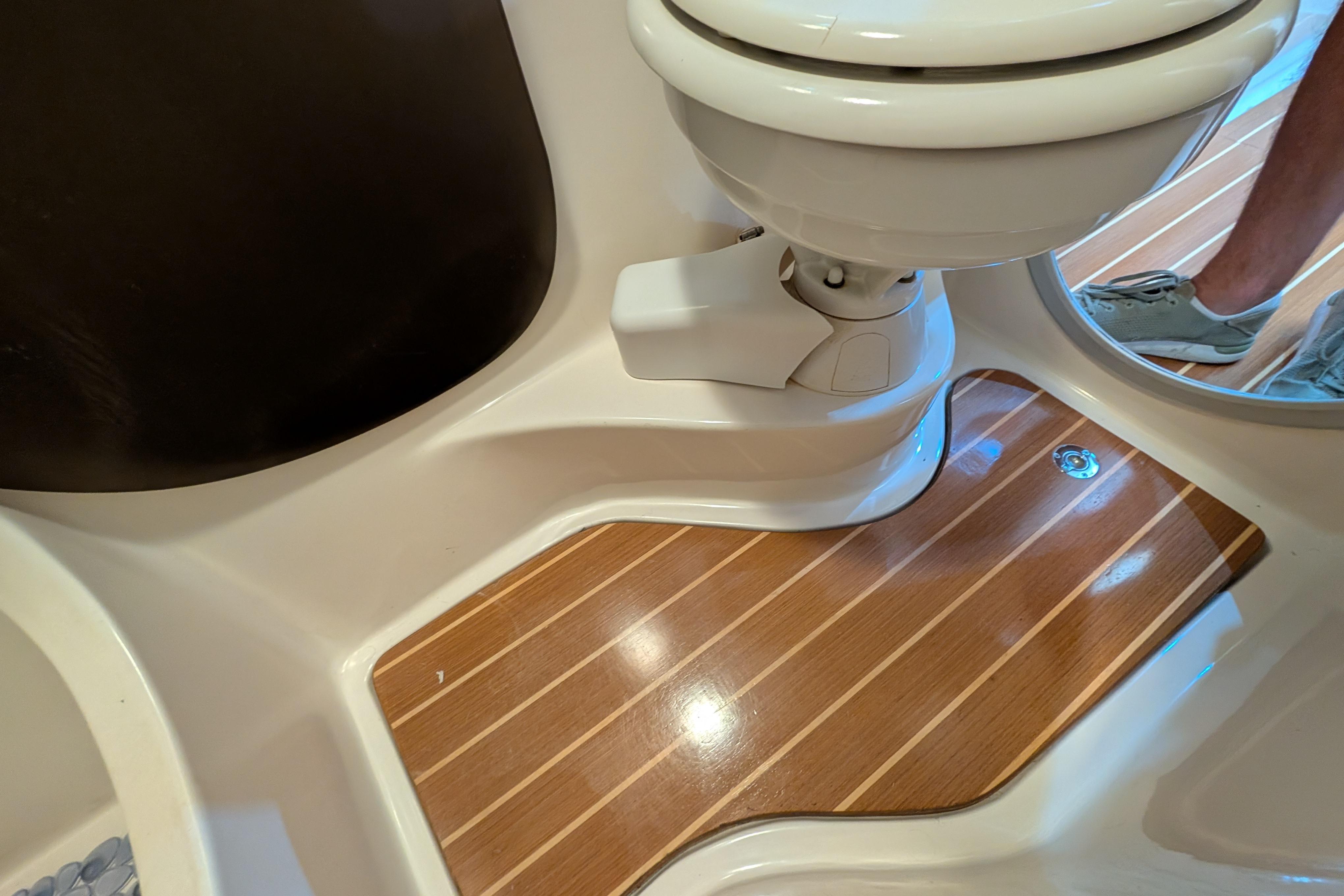 2004 PDQ 34 Powercat bathroom with wooden flooring and modern toilet design.