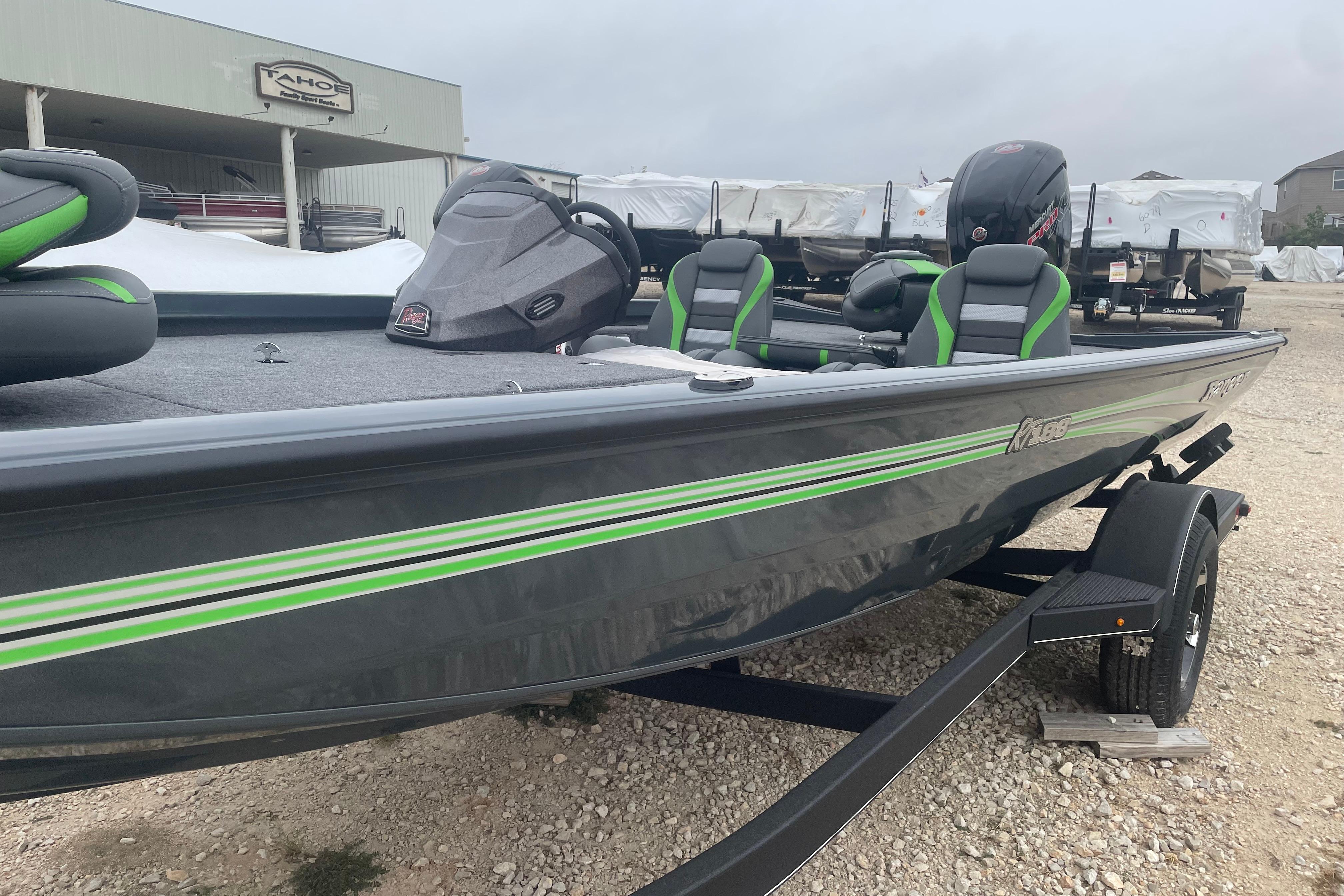 2026 Ranger RT188 boat with green accents on a trailer, parked outdoors.