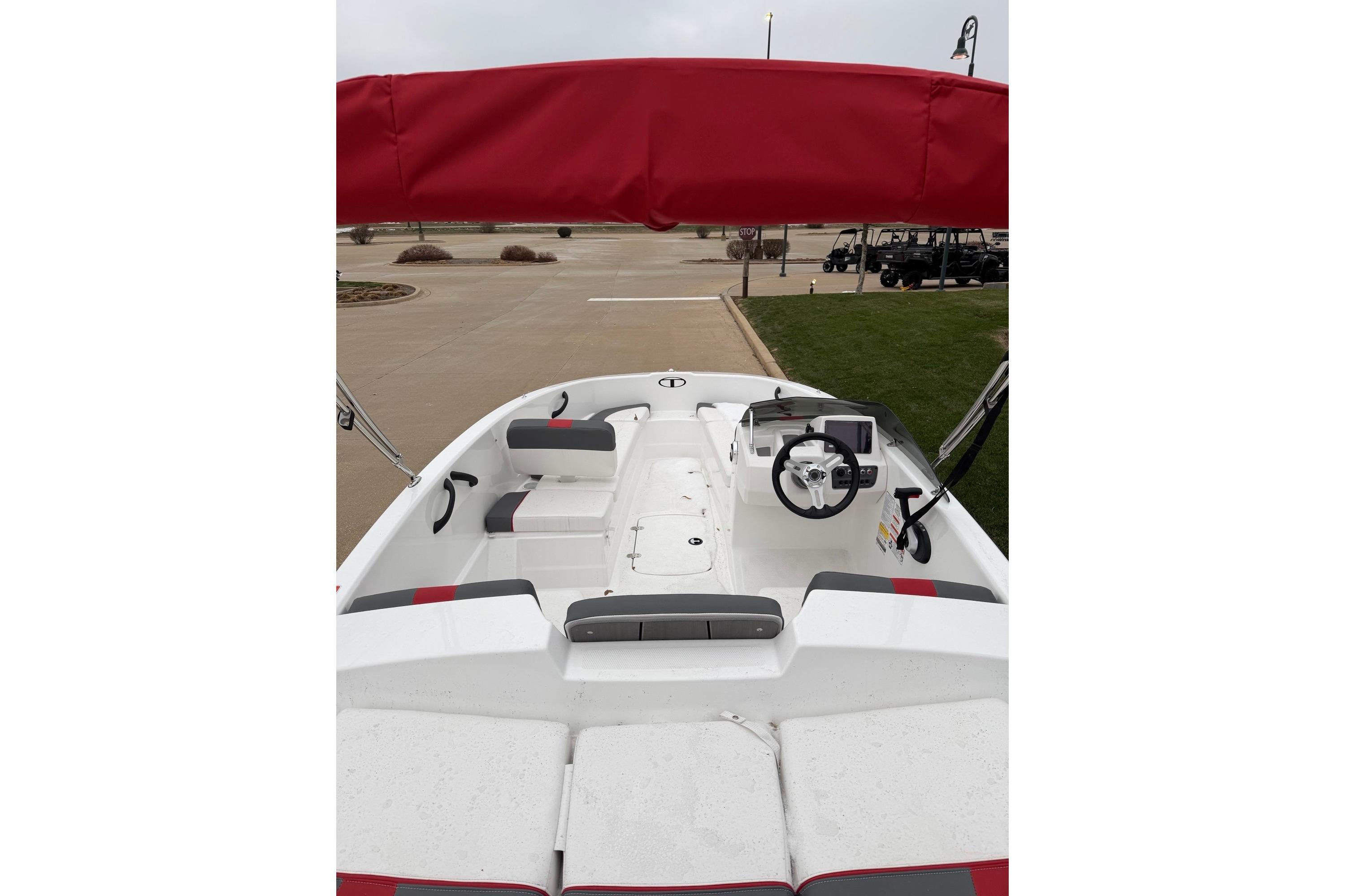 2025 Tahoe T16 boat interior with red canopy and modern dashboard.