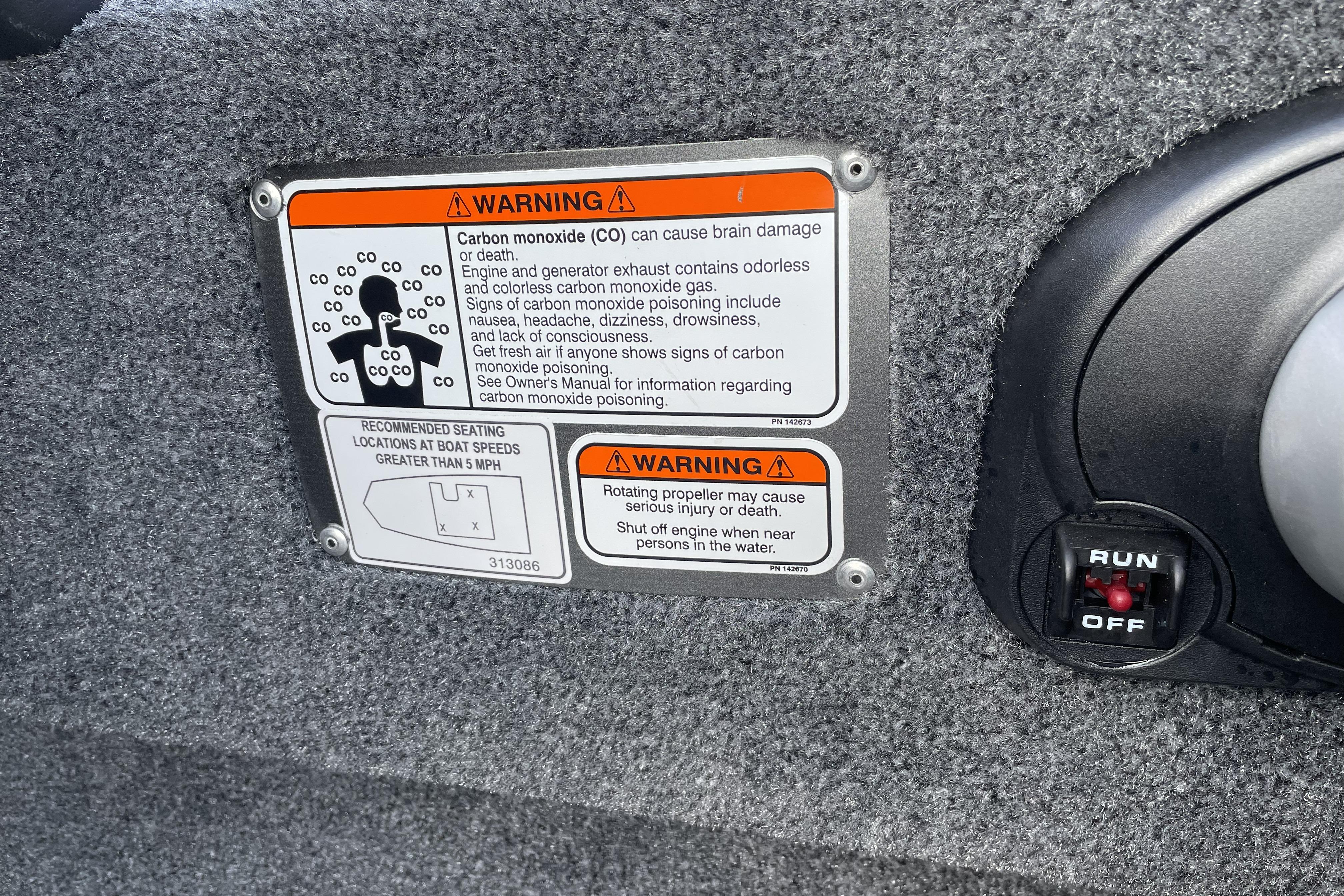 Warning labels on 2026 Tracker Bass Tracker Classic XL boat, highlighting carbon monoxide and propeller safety.