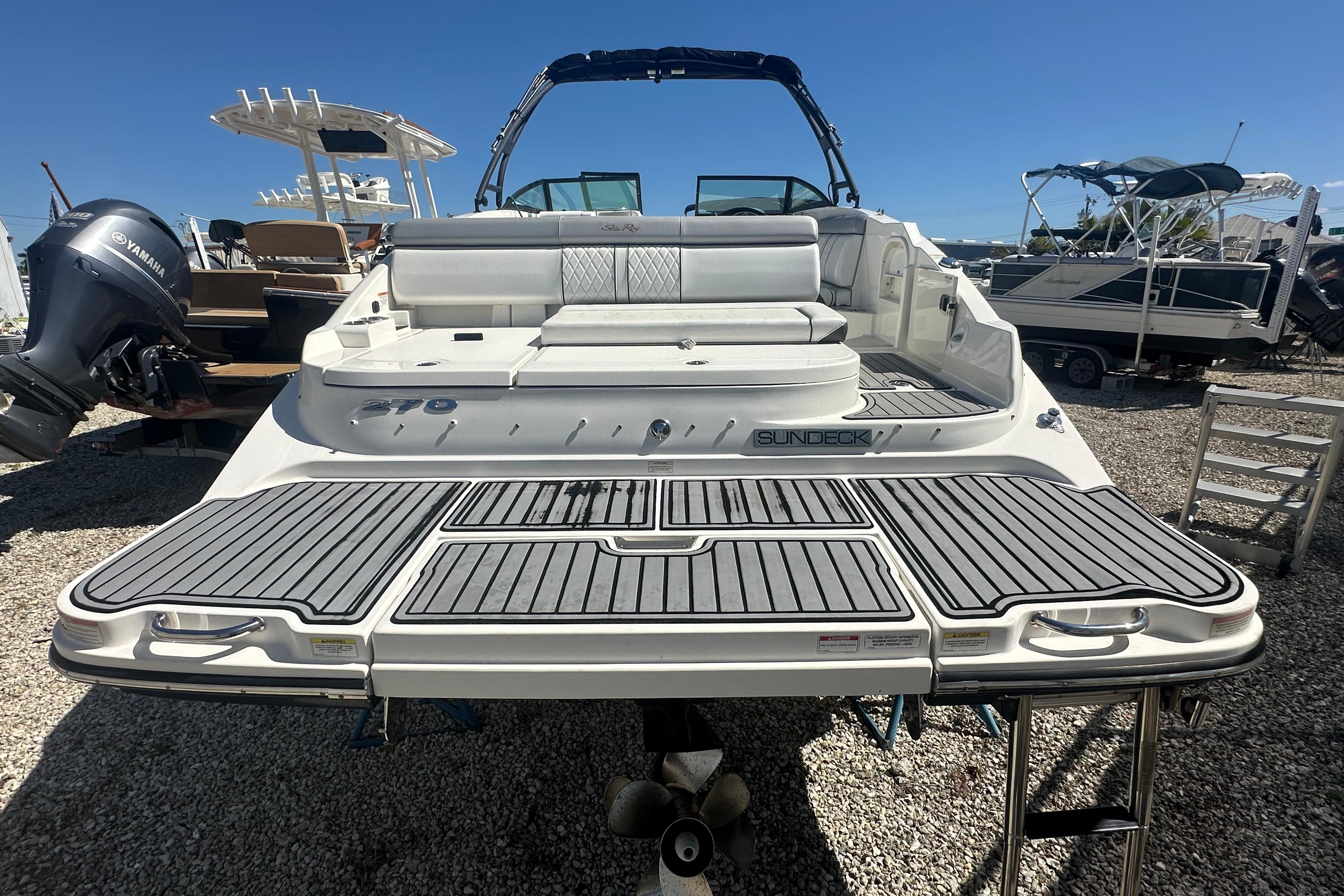2016 Sea Ray 270 Sundeck boat with spacious seating and swim platform, docked outdoors.