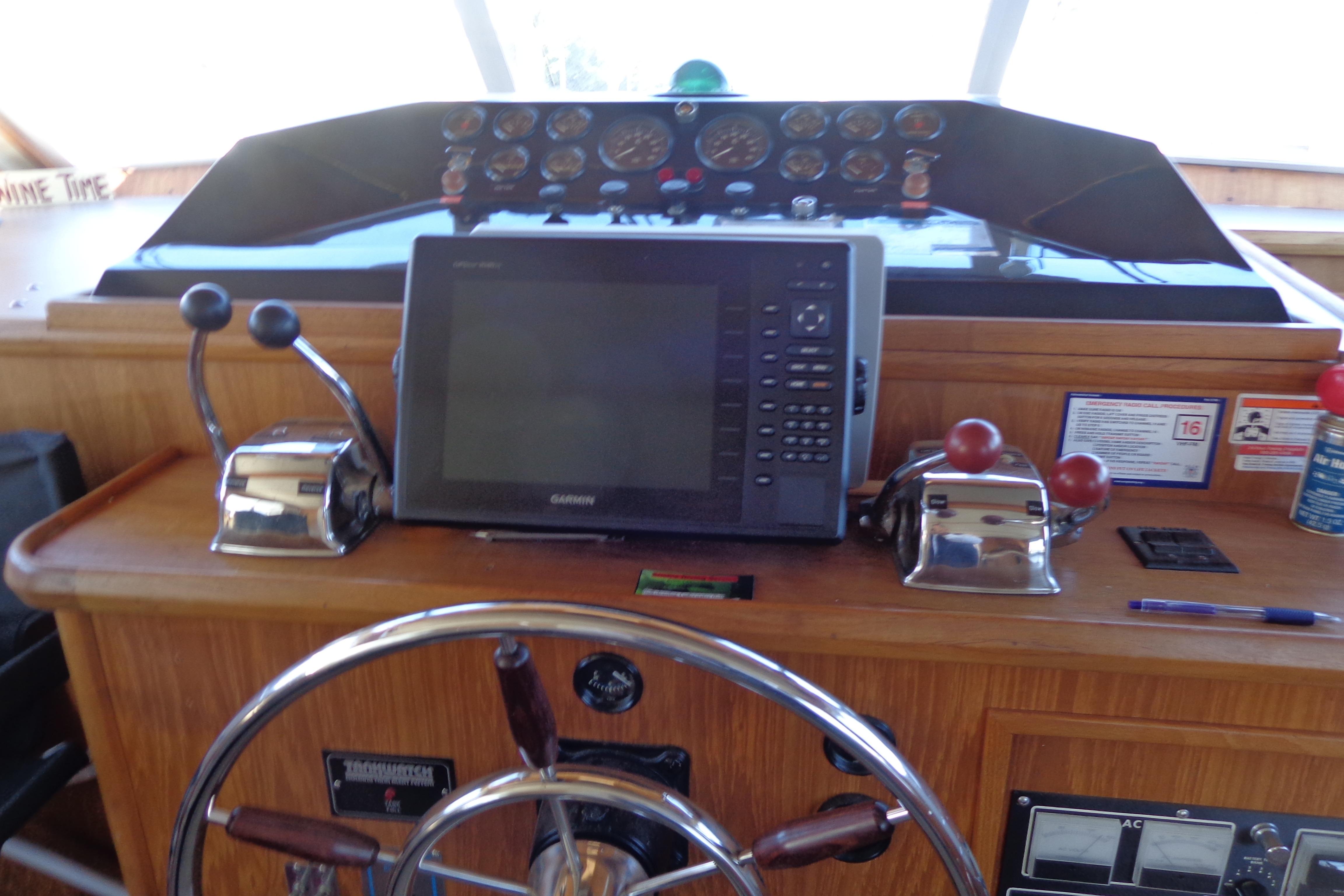 Helm of 1992 Cruise-A-Home Corsair 4200 with navigation equipment and controls.