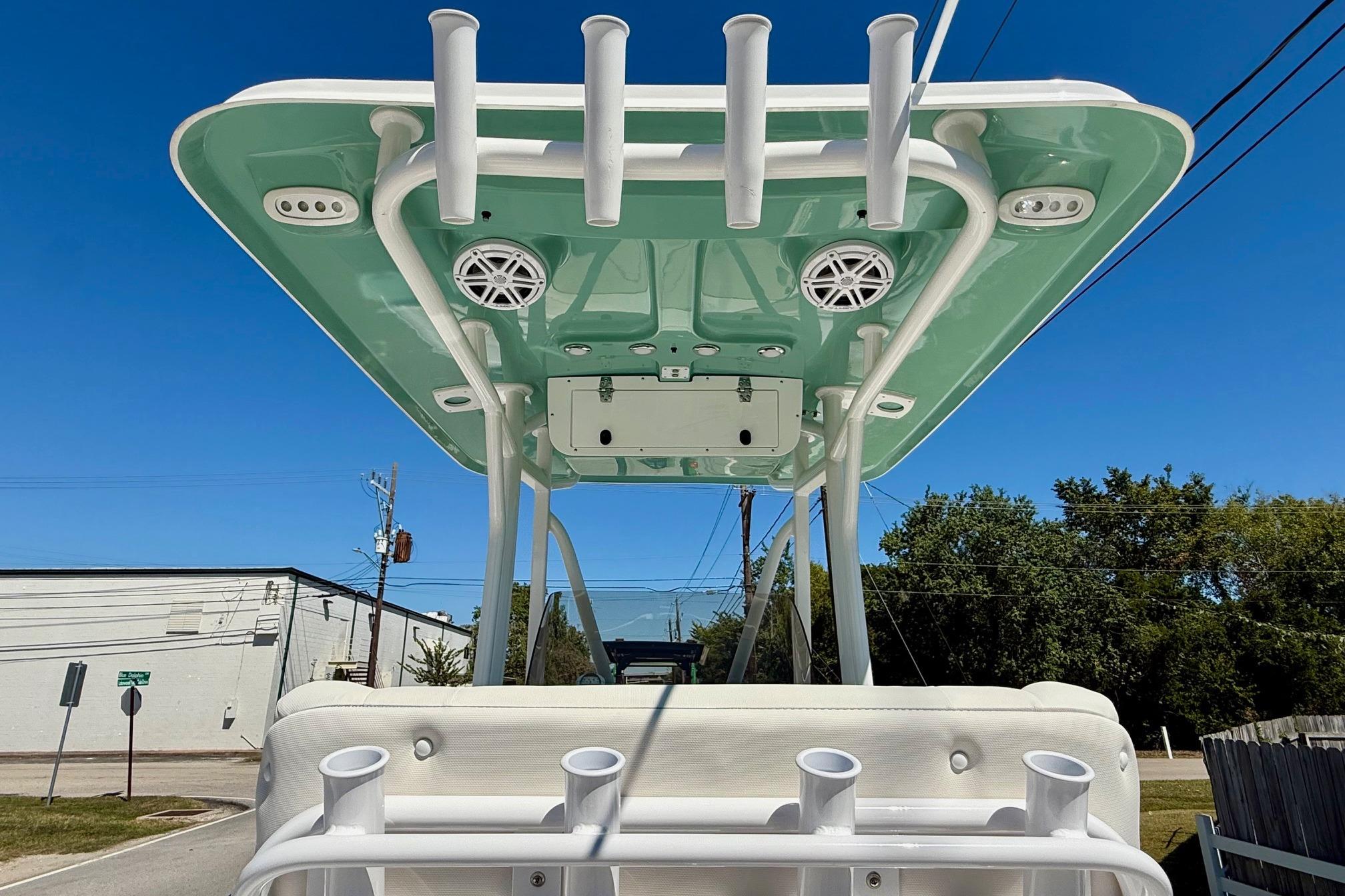2026 Sea Hunt Ultra 229 boat with T-top and rod holders, viewed from below.