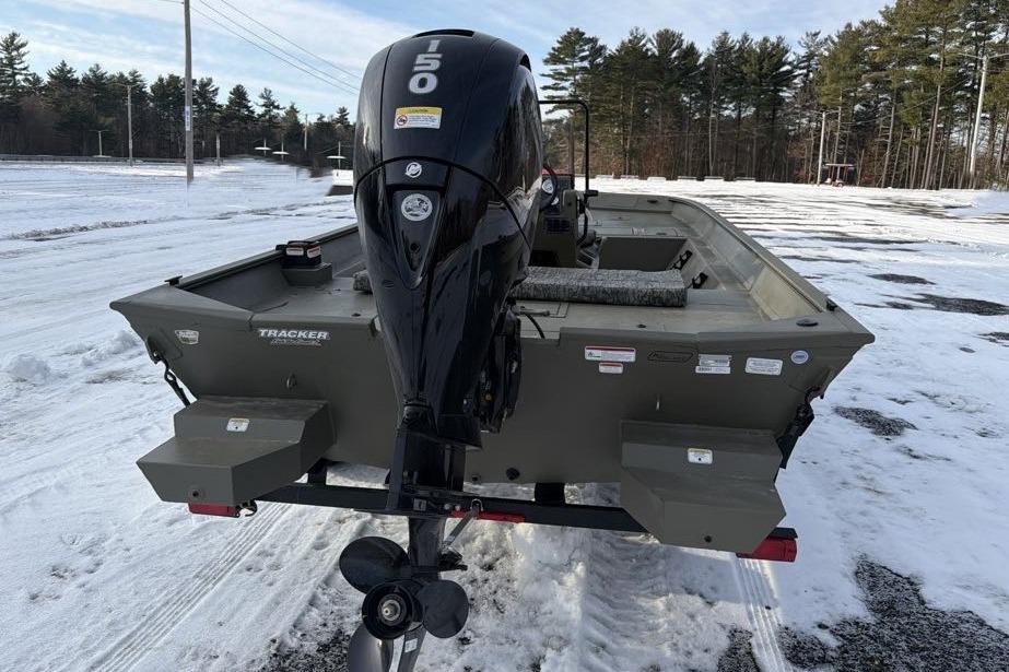 2026 Tracker Grizzly 2072 CC boat with powerful outboard motor on snowy ground.