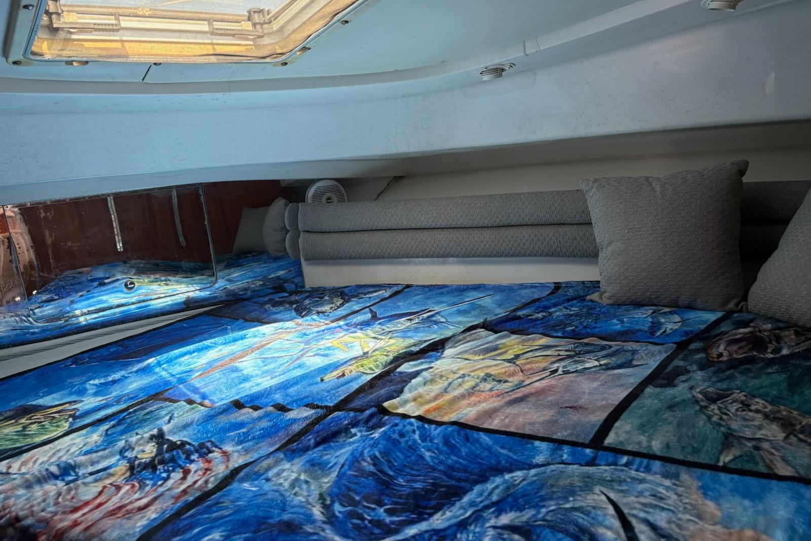 Interior cabin of 2008 Stamas 370 Express with vibrant marine-themed bedding.
