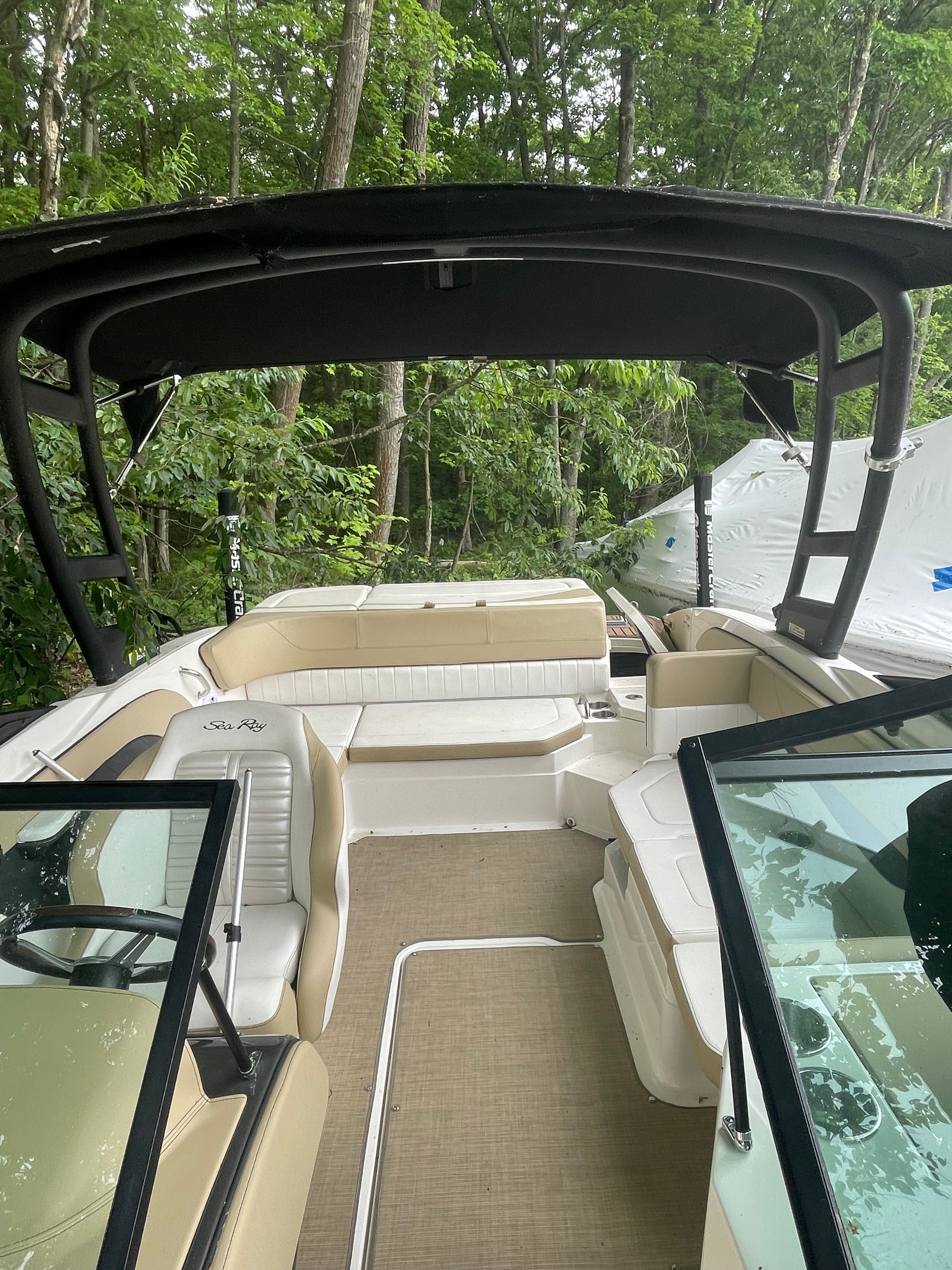 Interior view of a 2016 Sea Ray 21 SPX boat in the woods.