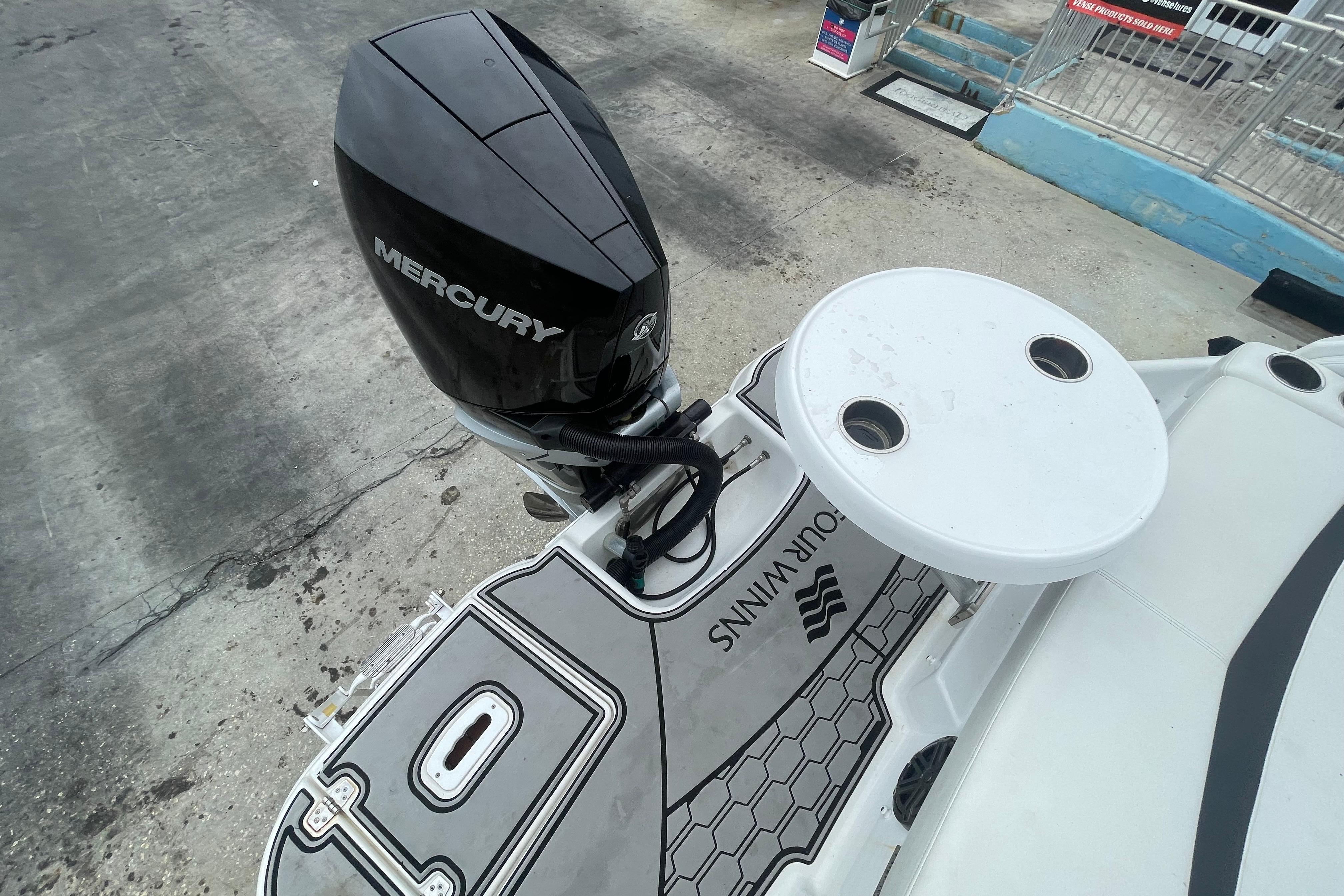 2022 Four Winns HD8 OB boat with Mercury outboard motor and deck table.