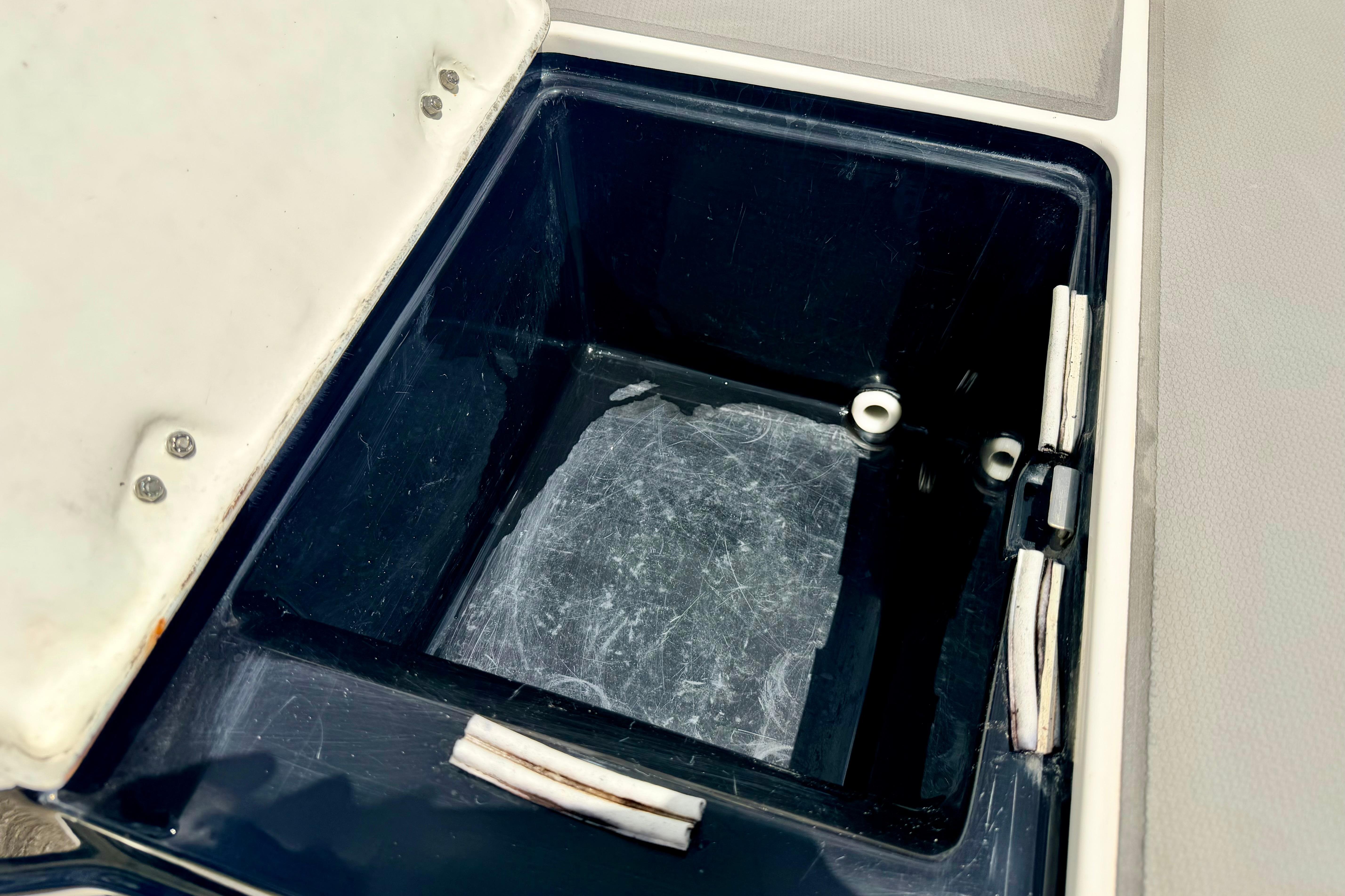Open storage compartment on a 2015 Chaparral Sunesta 264 boat.