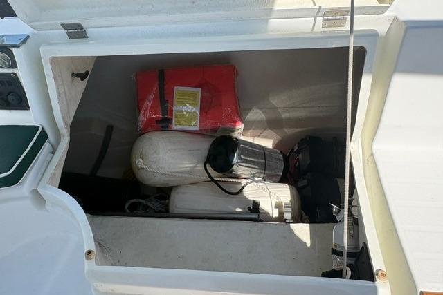 Storage compartment of a 2000 Beneteau Oceanis 321 sailboat with life jackets and equipment.