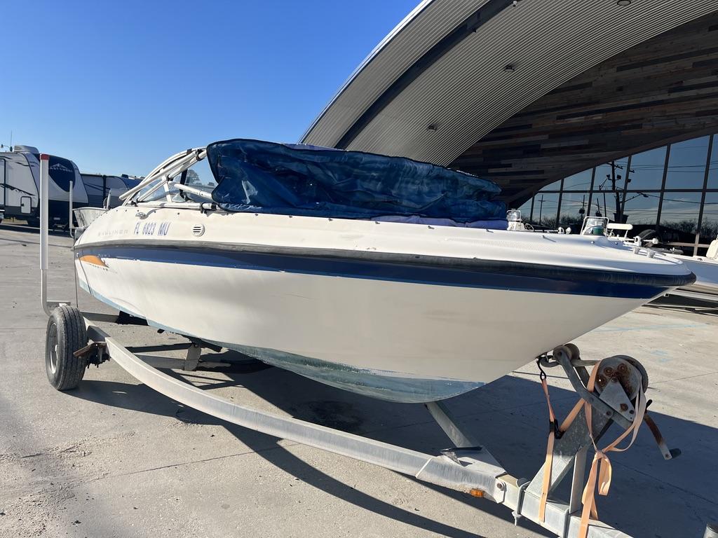 2004 Bayliner 175 boat on trailer in front of modern building.