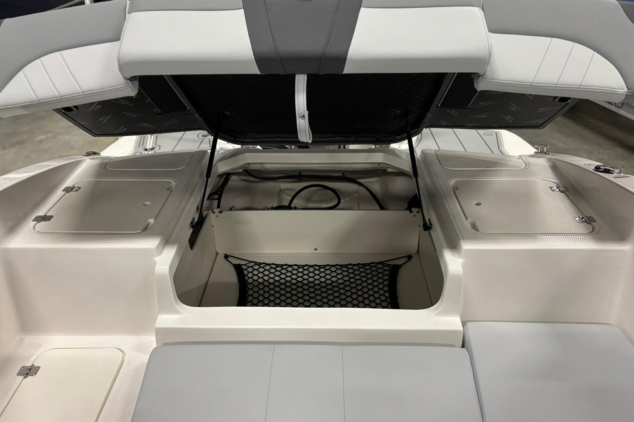 2026 Chaparral 21 SSi OB boat interior with open storage compartments and seating.
