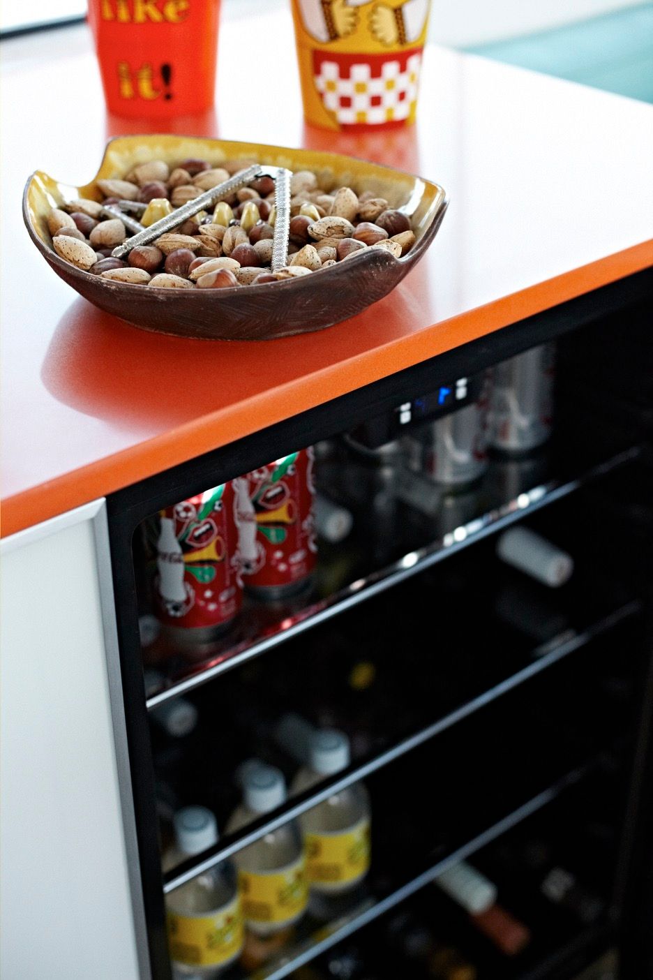 A table with a bowl of nuts and drinks on a houseboat.