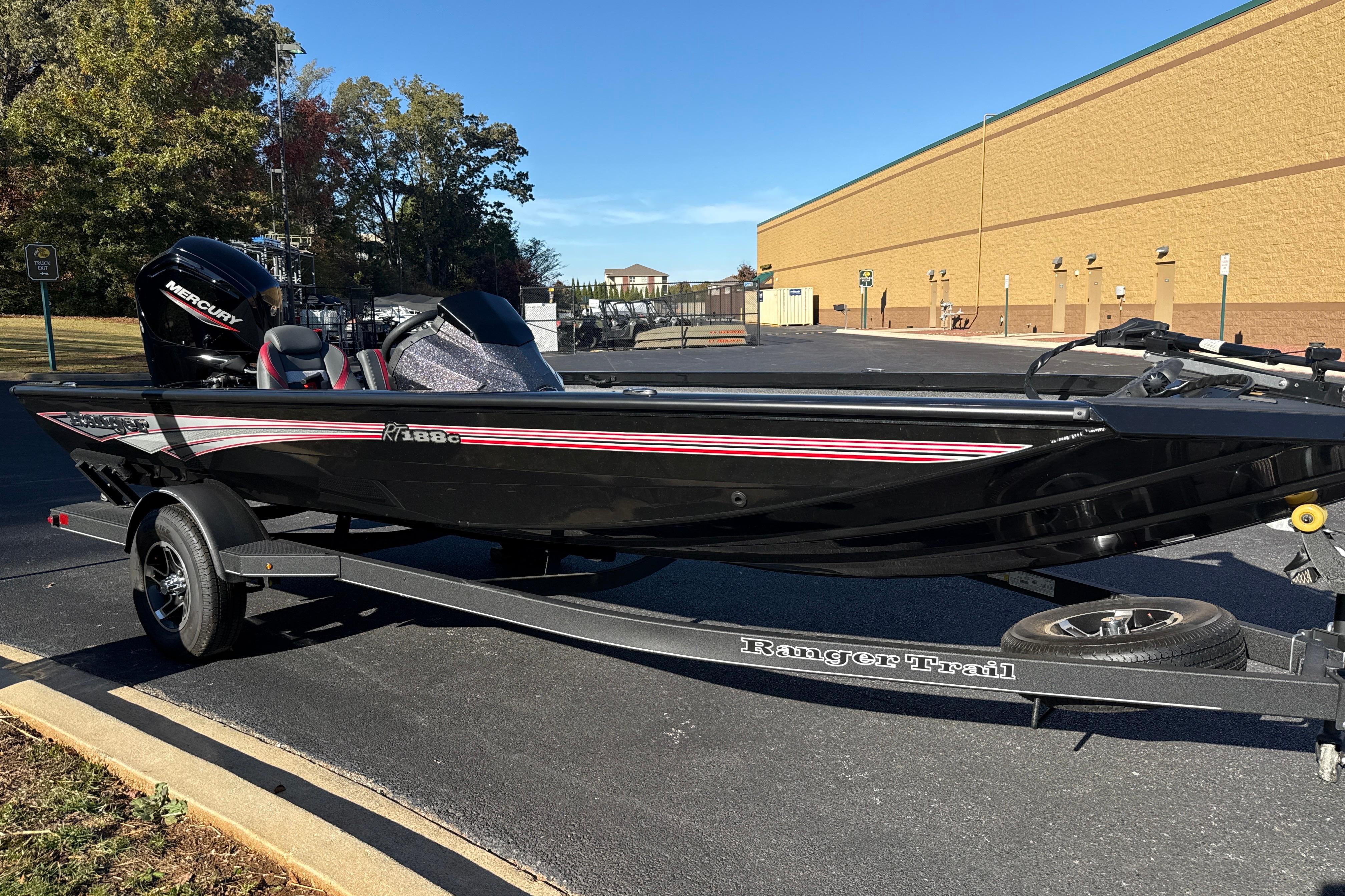 2025 Ranger RT188C fishing boat on trailer, parked outdoors.